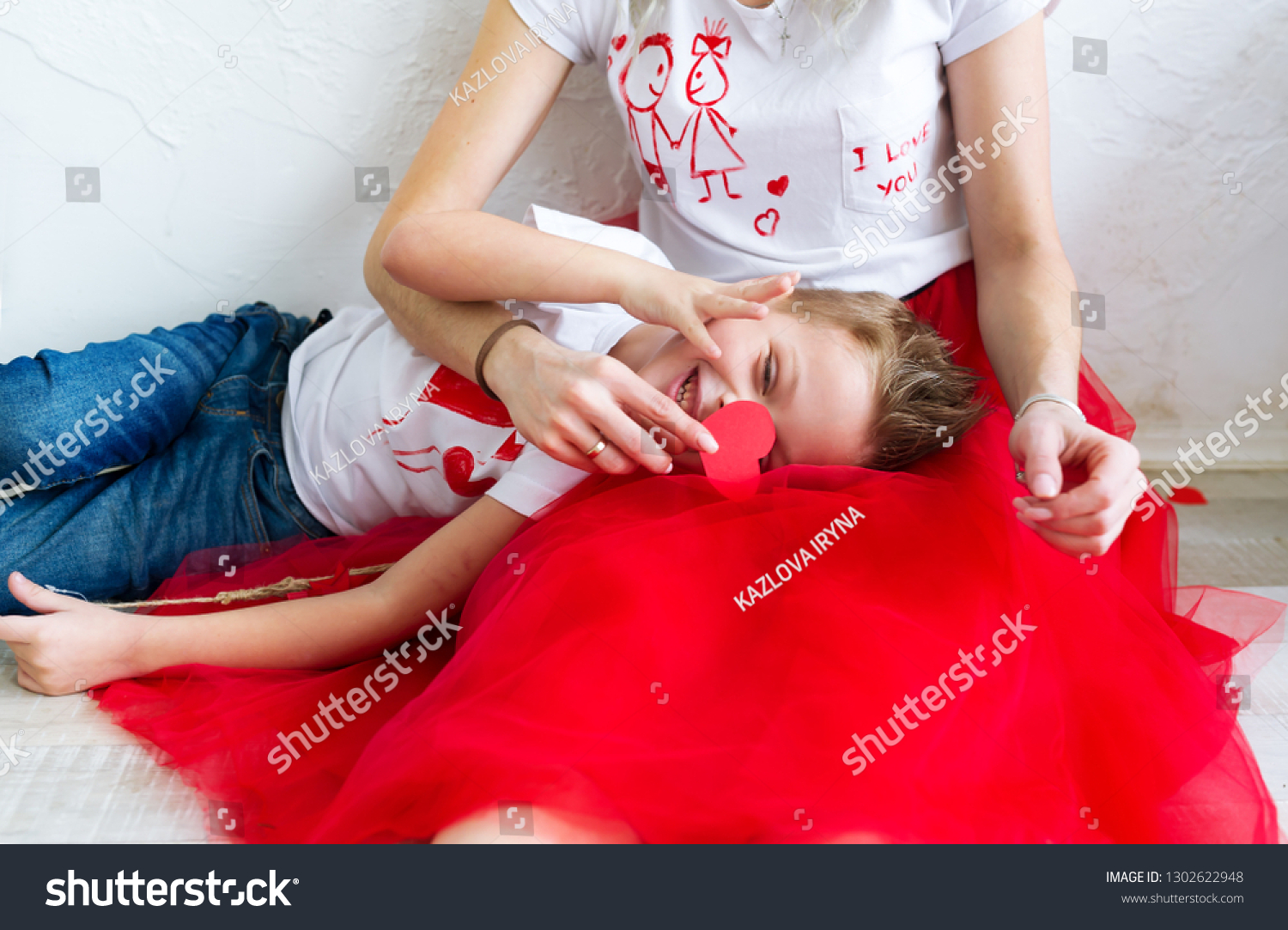 mom-son-sit-on-floor-against-stock-photo-1302622948-shutterstock