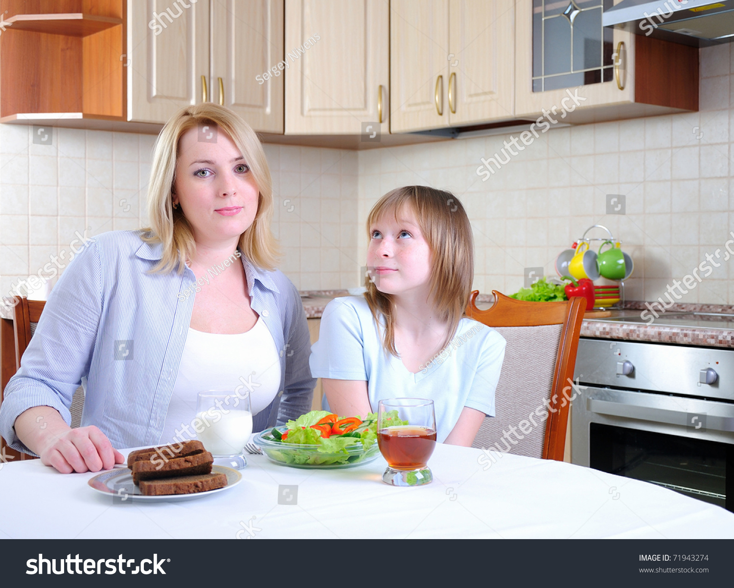 Mom And Young Daughter Eating Breakfast Together In The Kitchen Stock ...