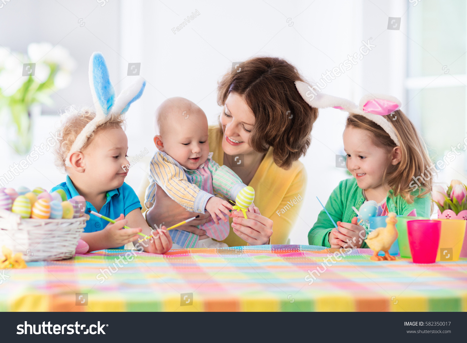 mother and children painting colorful eggs mom toddler preschooler and baby with bunny - Children Painting Images mother and children painting colorful eggs mom toddler preschooler and baby with bunny - Children Painting Images