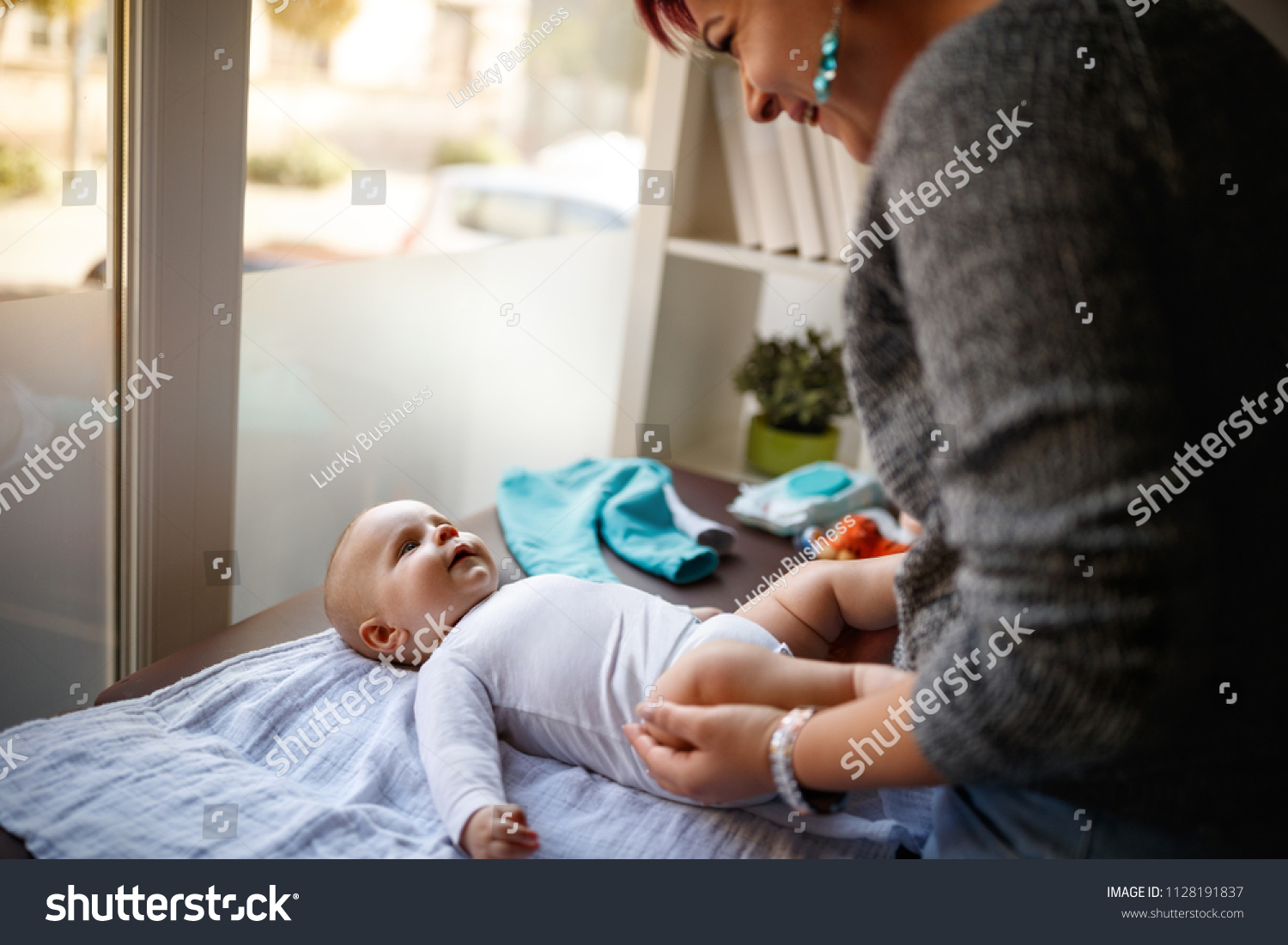  Violet Classic  Template Design Featuring Mother Changing Diapers to his little Son