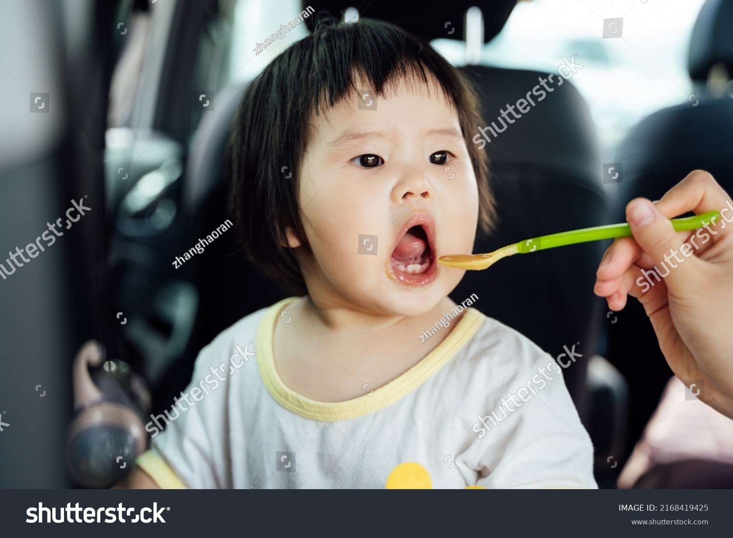 mother-feeding-10-month-old-baby-stock-photo-2168419425-shutterstock