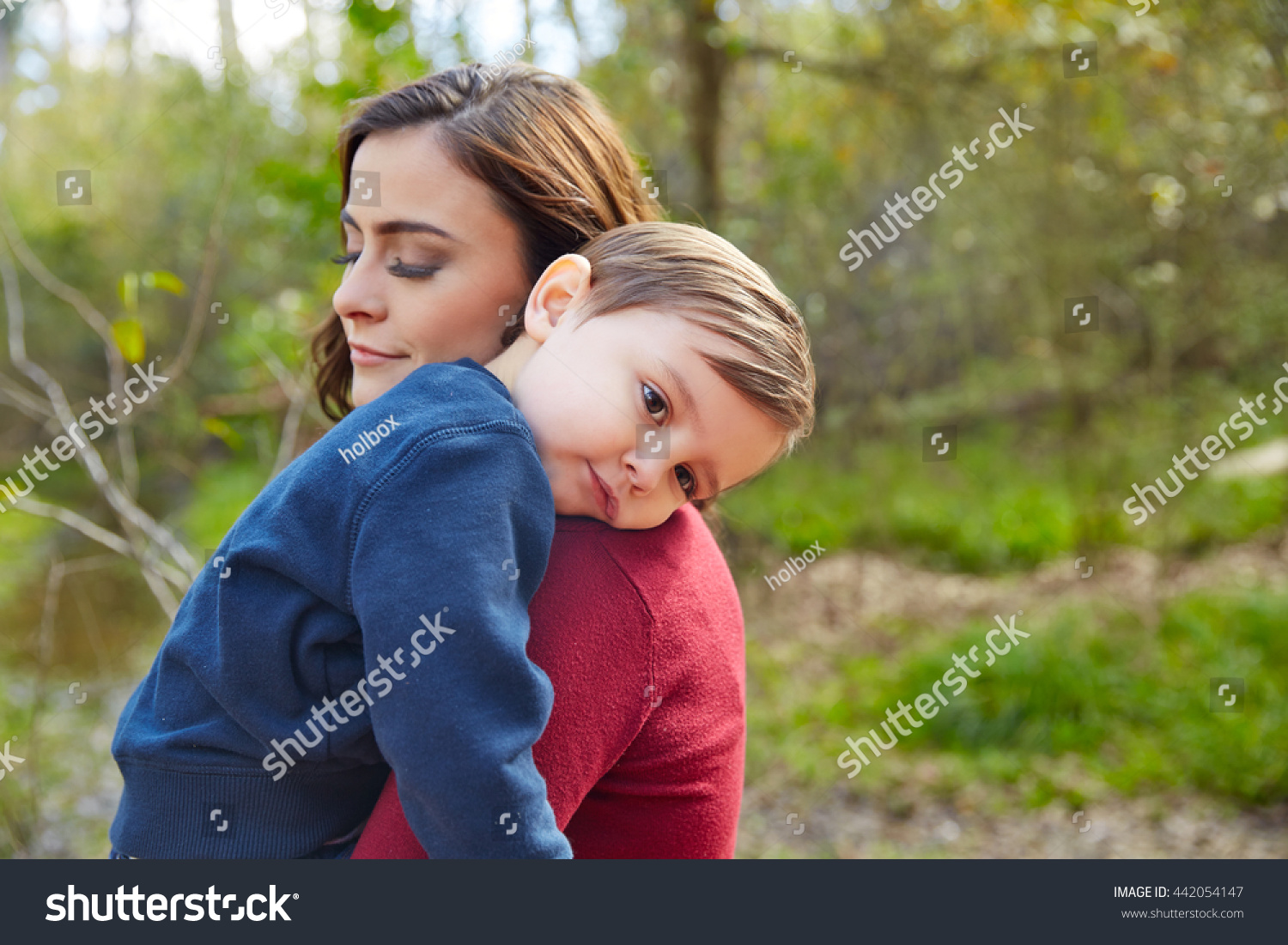 Mother Holding Kid Boy Tired In Her Shoulder At Park Stock Photo ...