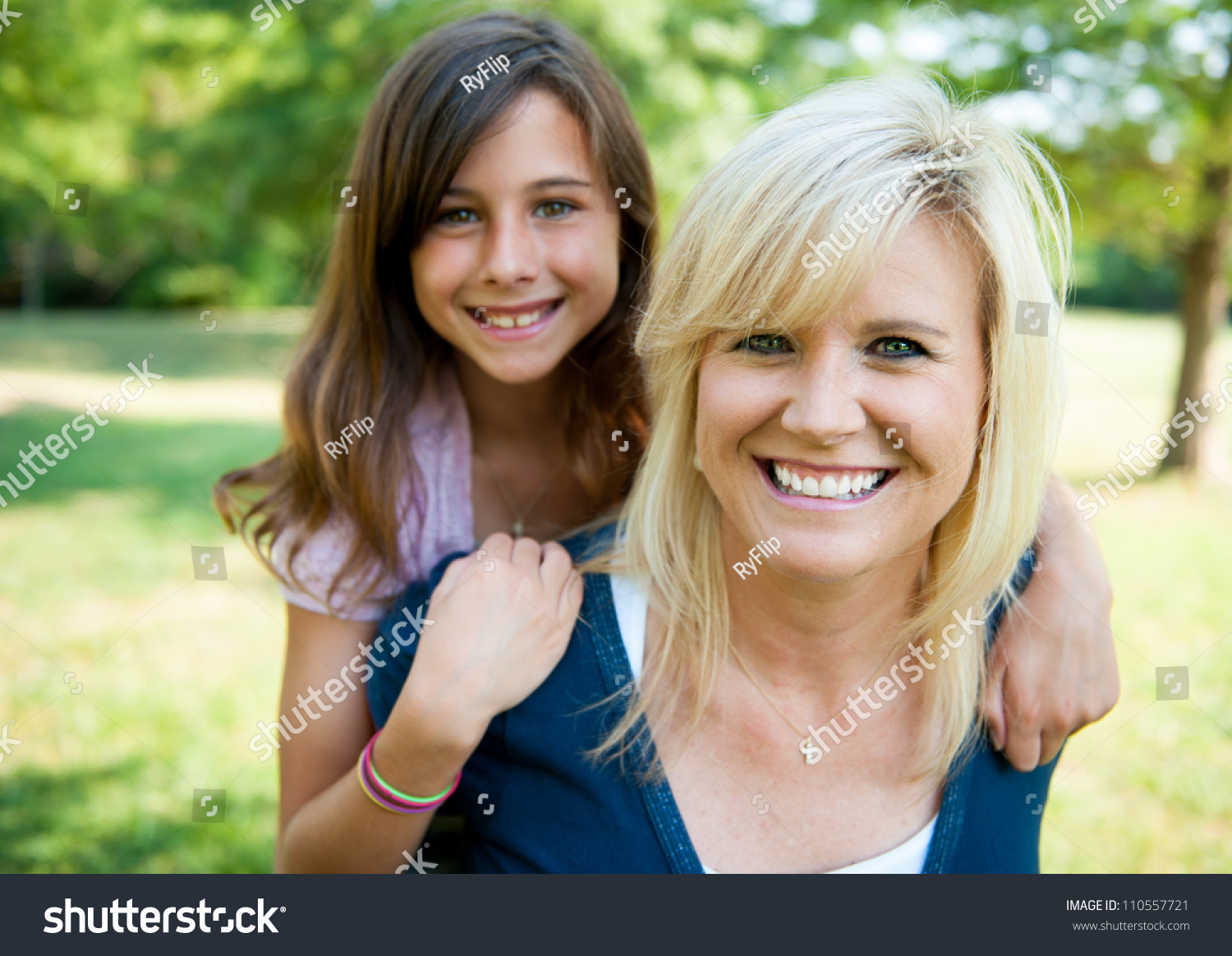 Mother With Young Daughter On Her Back Smiling Stock Photo 110557721 ...