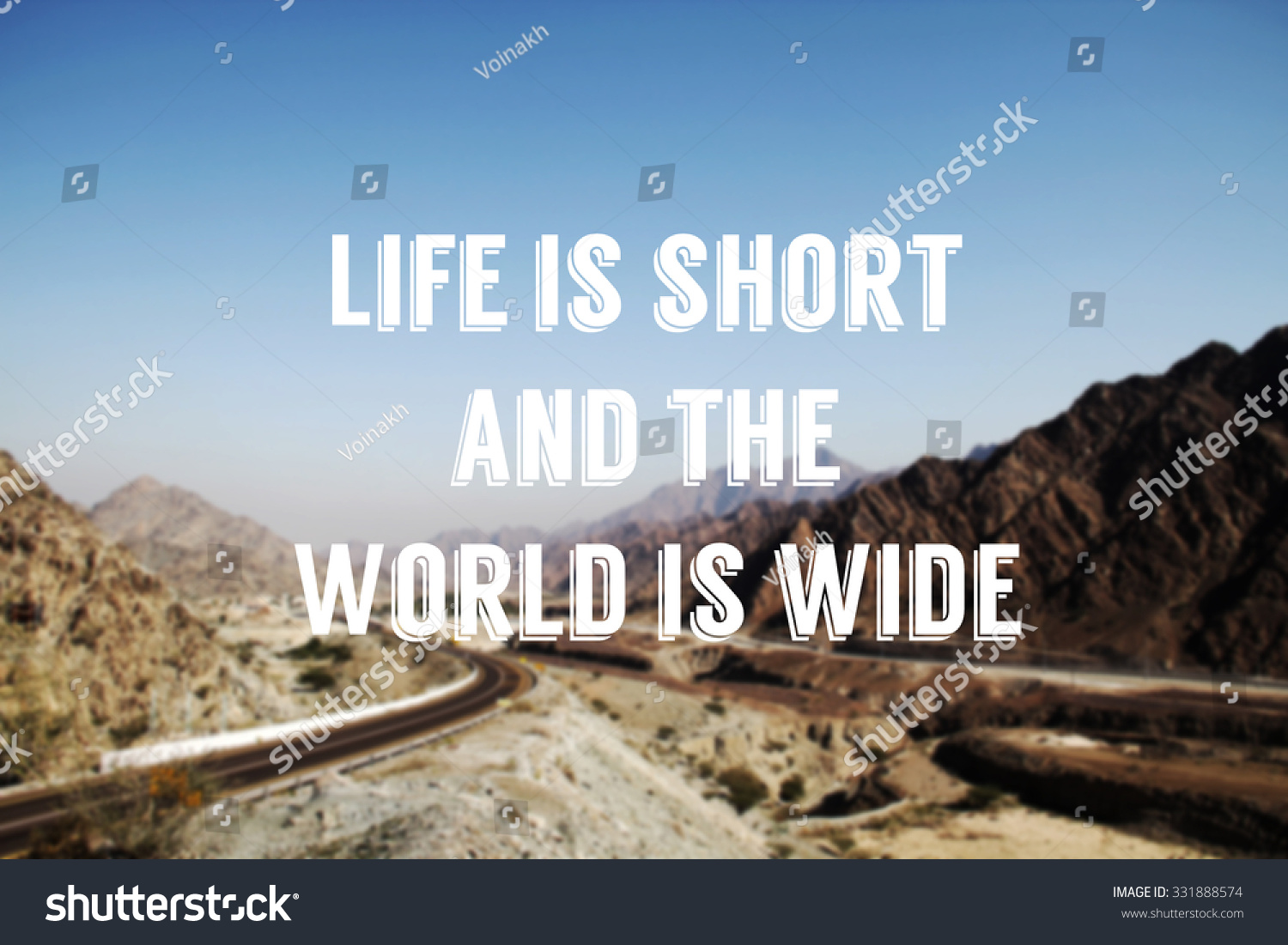 Mountain road in UAE with quote Life is short and the world is wide