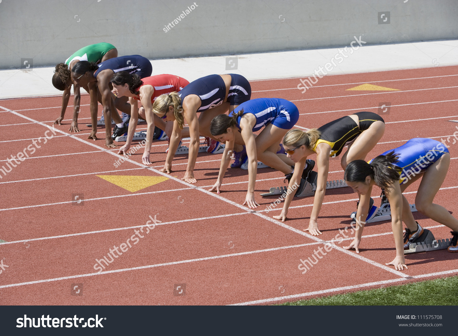 Female Athletes At The Starting Line Of A 400m Race On Track