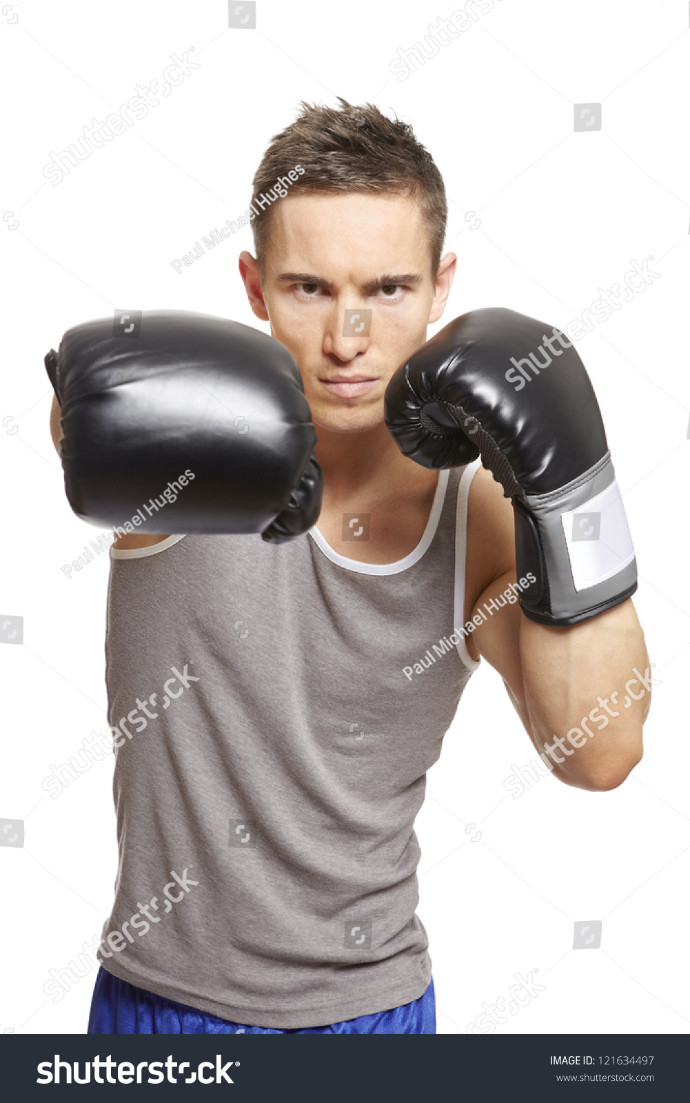 Muscular Young Man With Boxing Gloves Throwing A Punch In Sports Outfit ...