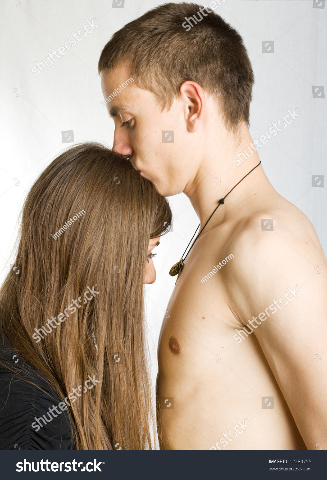 a naked man kissing naked girl