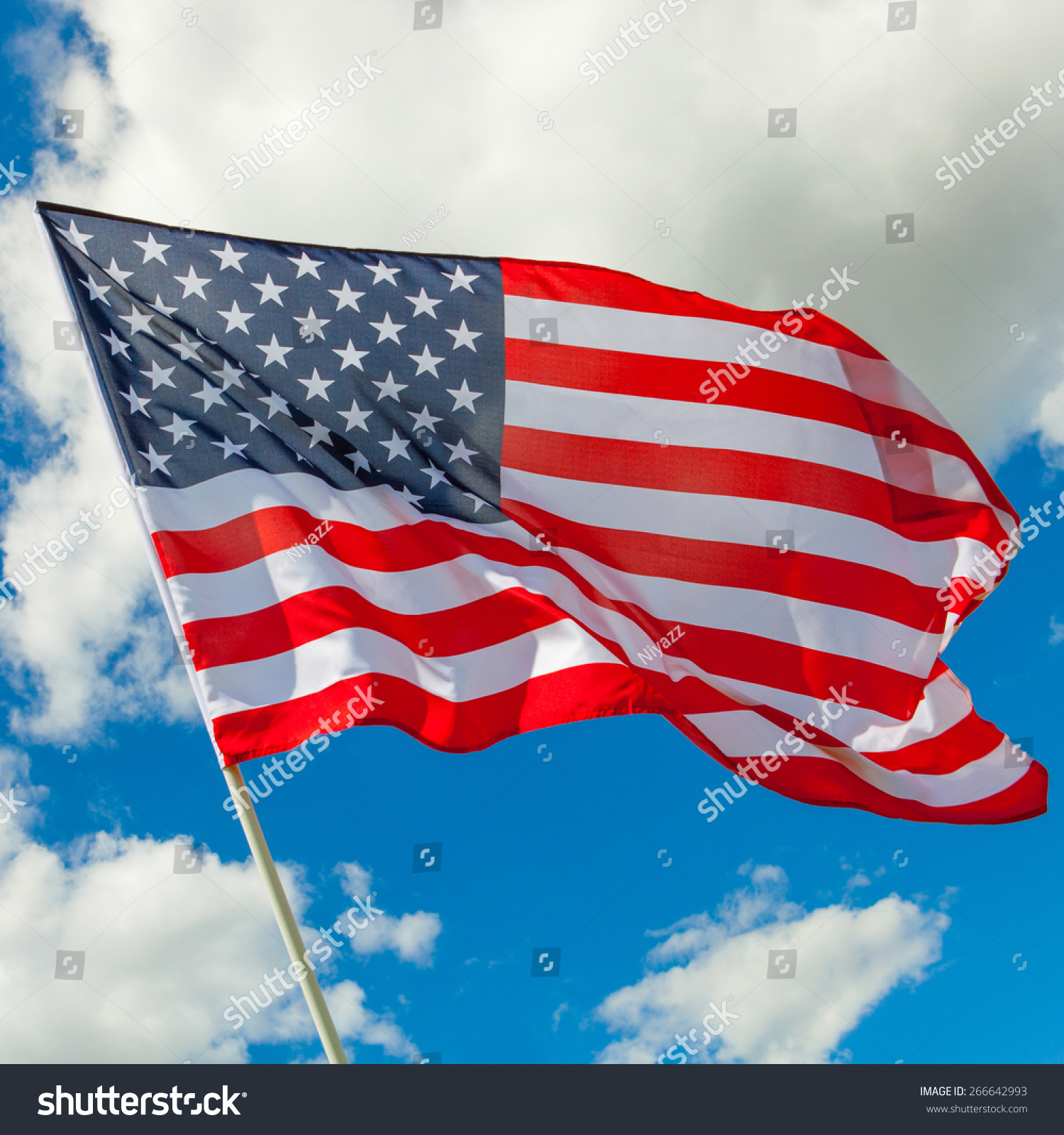 Neat Us Flag And Cumulus Clouds Behind It Stock Photo 266642993 ...