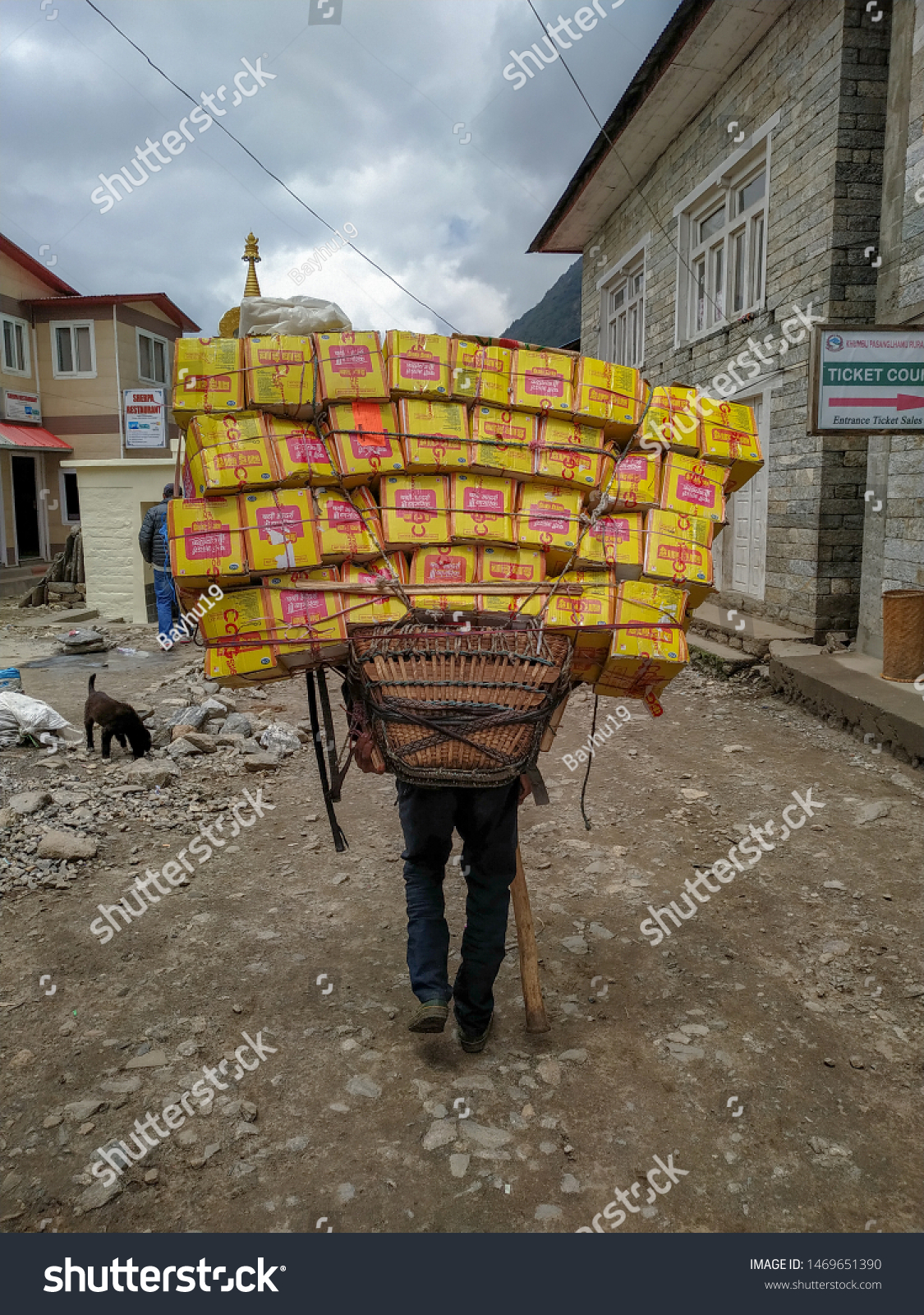 stock-photo-nepal-lukla-april-sherpa-porter-carries-boxes-with-food-drinks-and-other-stuff-on-the-1469651390.jpg