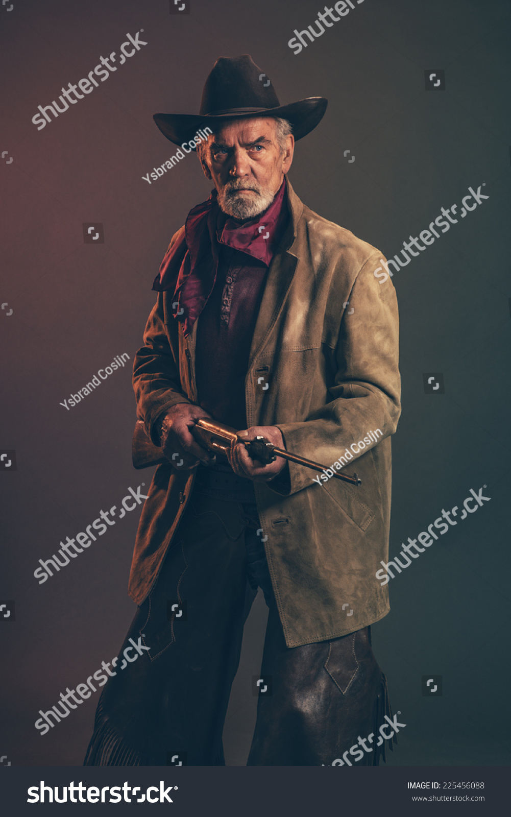 Old Rough Western Cowboy With Gray Beard And Brown Hat Holding Rifle ...