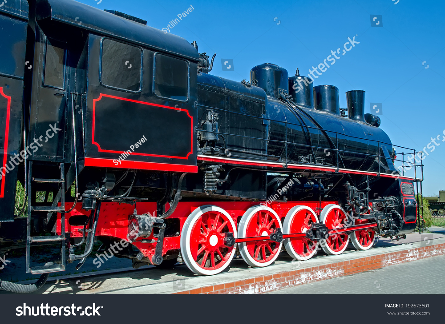 Old Russian Soviet Steam Locomotive On A Pedestal On A Background