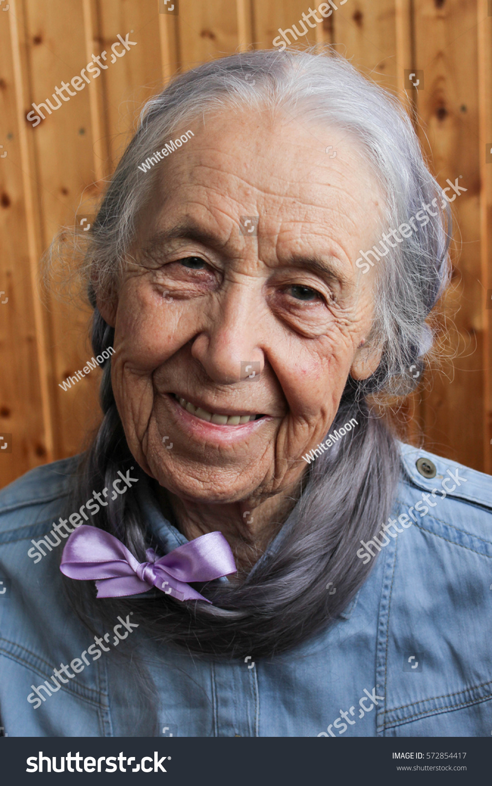 Portrait of happy mature woman with long gray hair 
