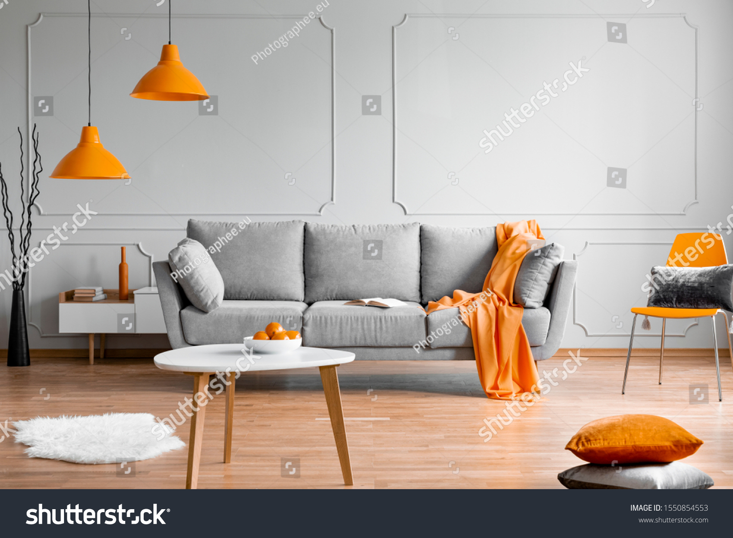 Stock Photo Orange Lamp Above Grey Scandinavian Sofa In Modern Interior 1550854553 