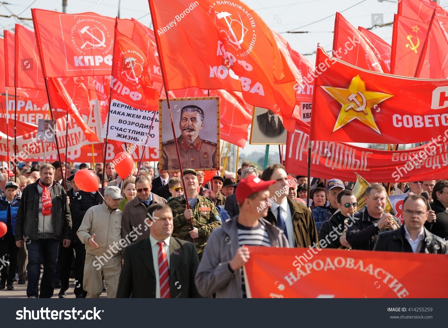 Orel, Russia - May 1, 2016: Communist party demonstration. People carrying red flags and Stalin's portrait