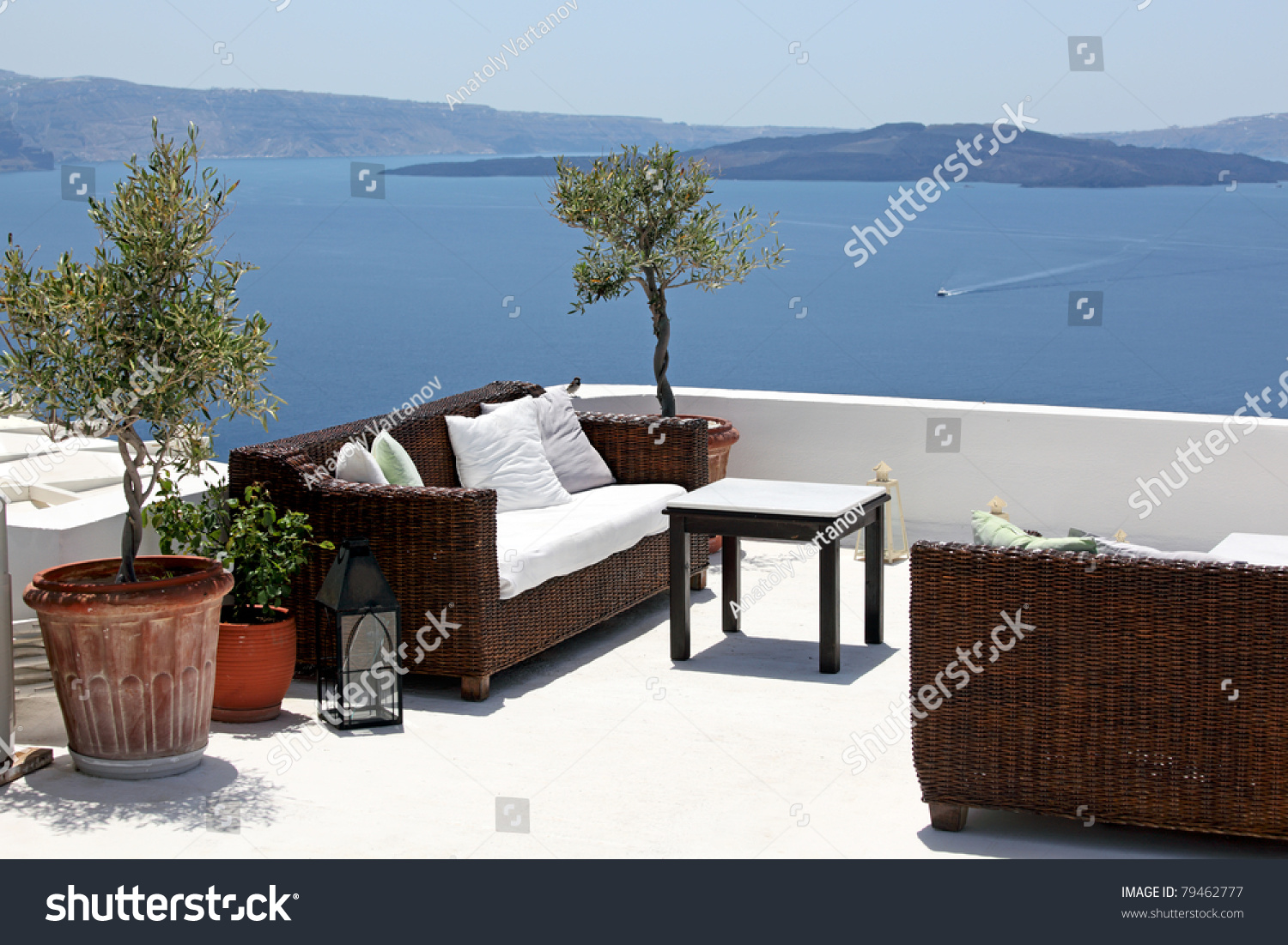 Outdoor Table And Sofas On Terrace Overlooking Sea, Oia Village ...