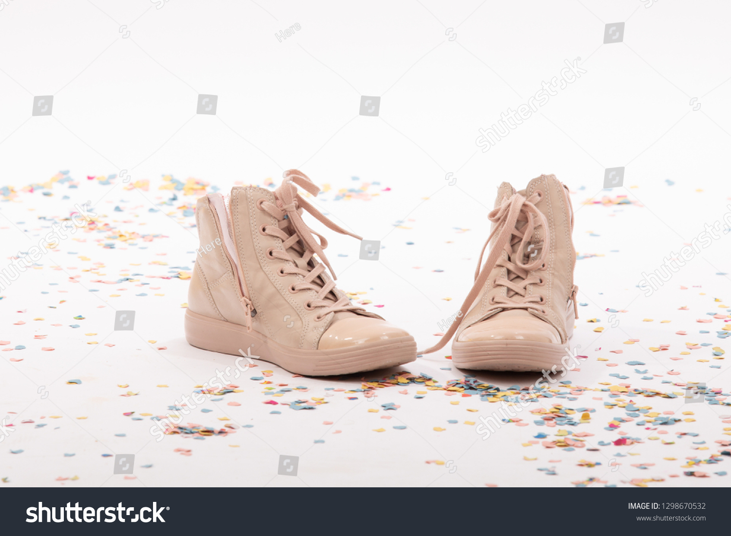 stock photo pair of fashionable shoes with laces for teen girls on white background with confetti birthday 1298670532