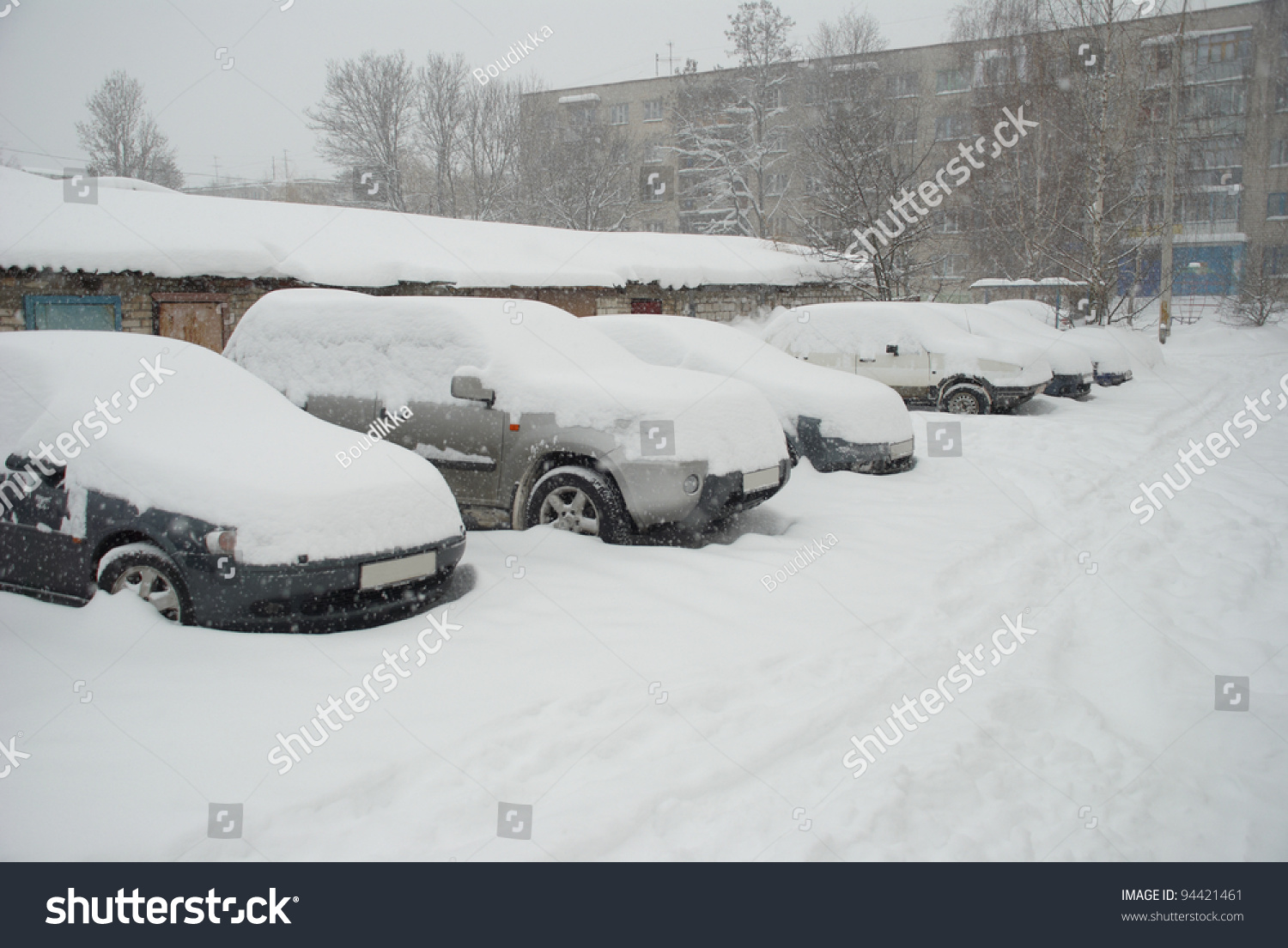 Parked Cars Covered With Snow In The Winter Blizzard On The Street Of ...