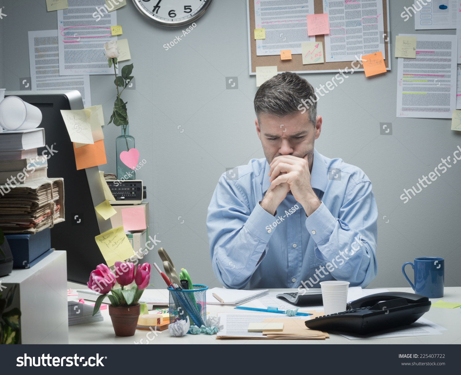 Pensive Businessman At Desk With Hands Clasped Looking Down. Stock ...