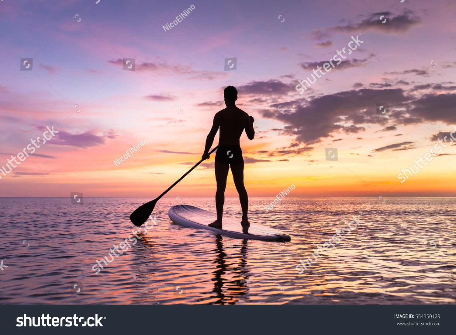 Person Stand Paddle Boarding Dusk On Stock Photo 554350129 - Shutterstock