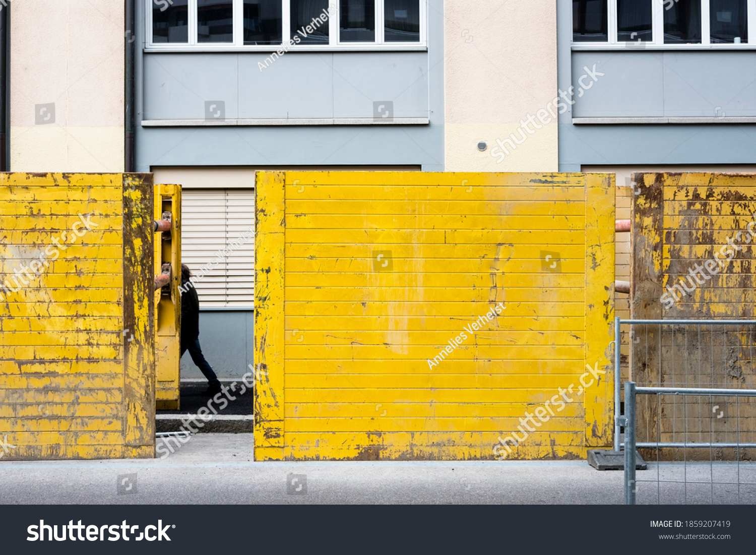 Person Walking Behind Yellow Containers Front Stock Photo 1859207419 ...