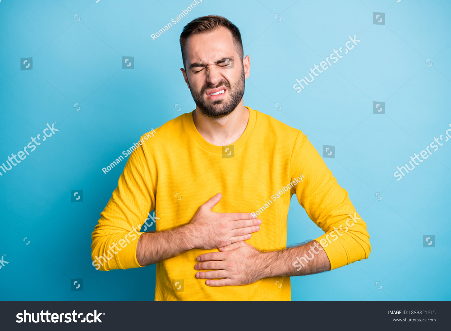 Photo Portrait Man Grimacing Touching Stomach Stock Photo 1883821615 ...