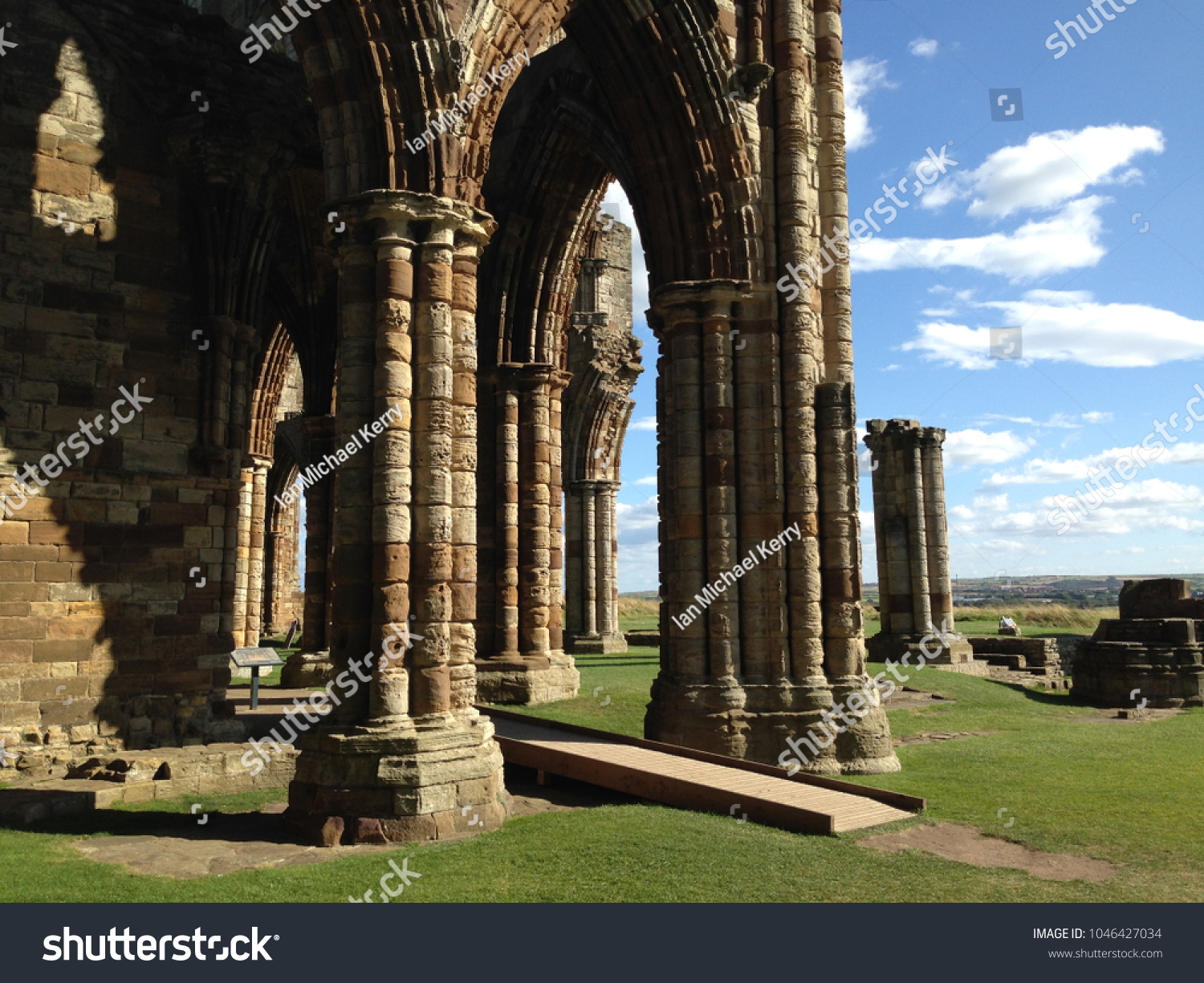 Pillars supporting the remains of an abandoned church in England, Europe. Blue sky with