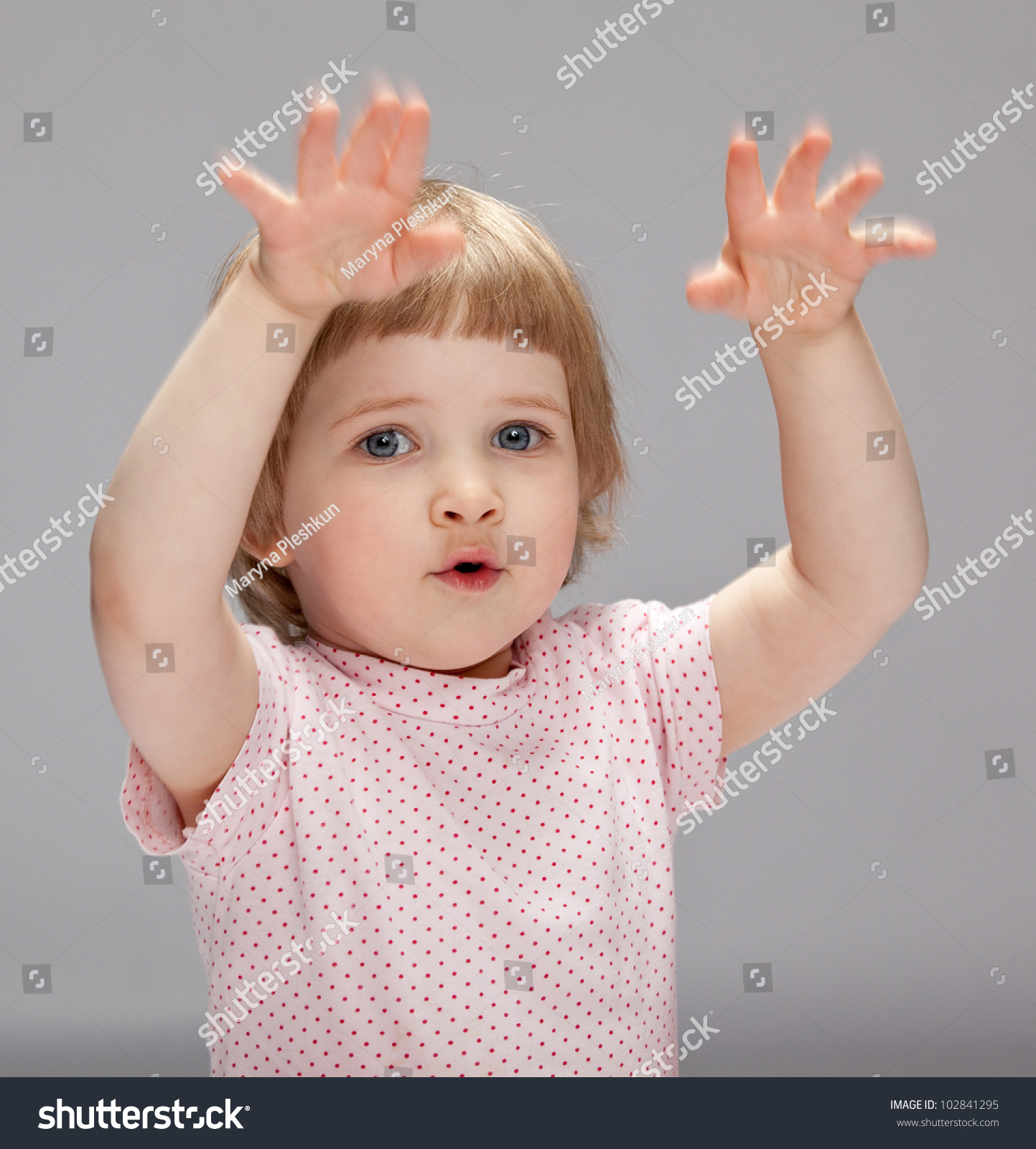 Playful Little Girl Showing Something Big With Her Hands; Studio Shot ...