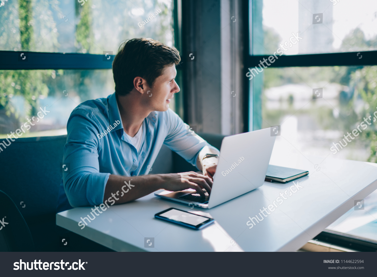 Pondering Young Man Looking Out Window Stock Photo (Edit Now) 1144622594