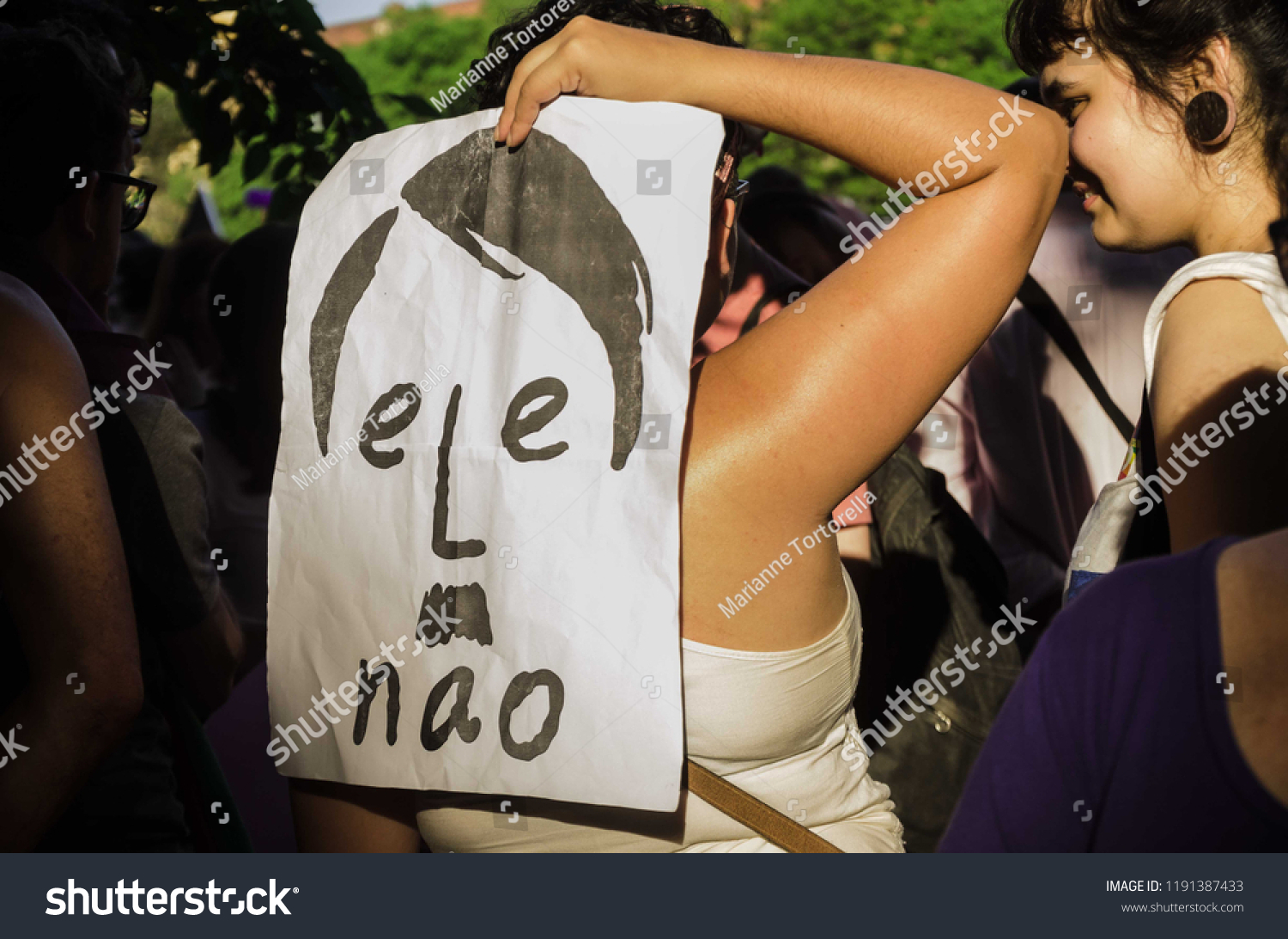 PORTO ALEGRE, BRAZIL - SEPTEMBER 29, 2018: Woman holding a Hitler sign against Bolsonaro during brazilian elections
