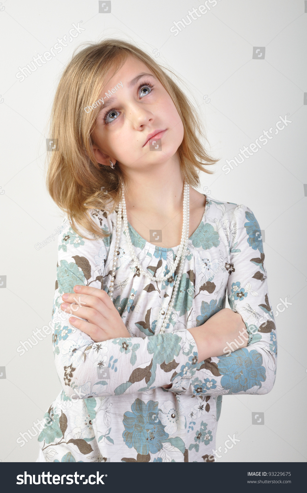 Portrait Of A Beautiful Elementary Age Girl With Her Hands Crossed On ...