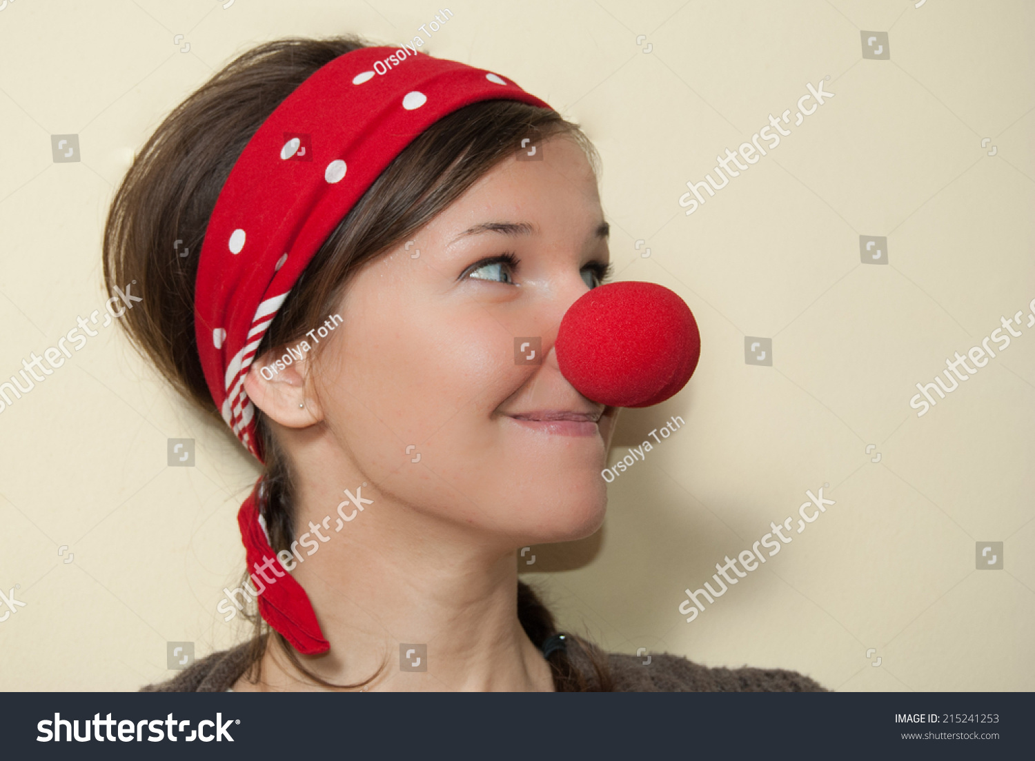 stock-photo-portrait-of-a-girl-with-red-clown-nose-215241253.jpg