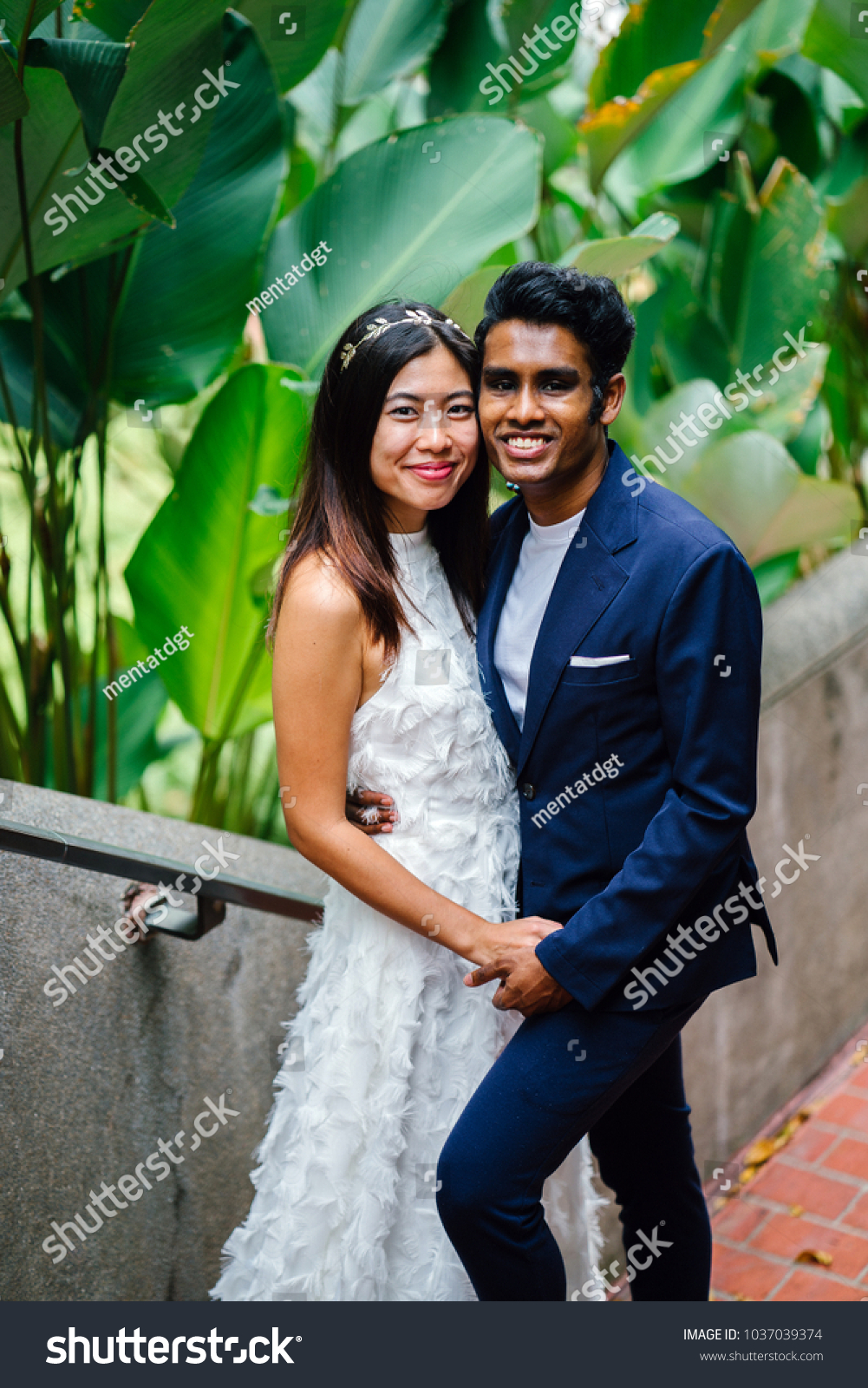 stock-photo-portrait-of-a-happy-interracial-asian-couple-indian-man-chinese-woman-taking-wedding-photographs-1037039374.jpg