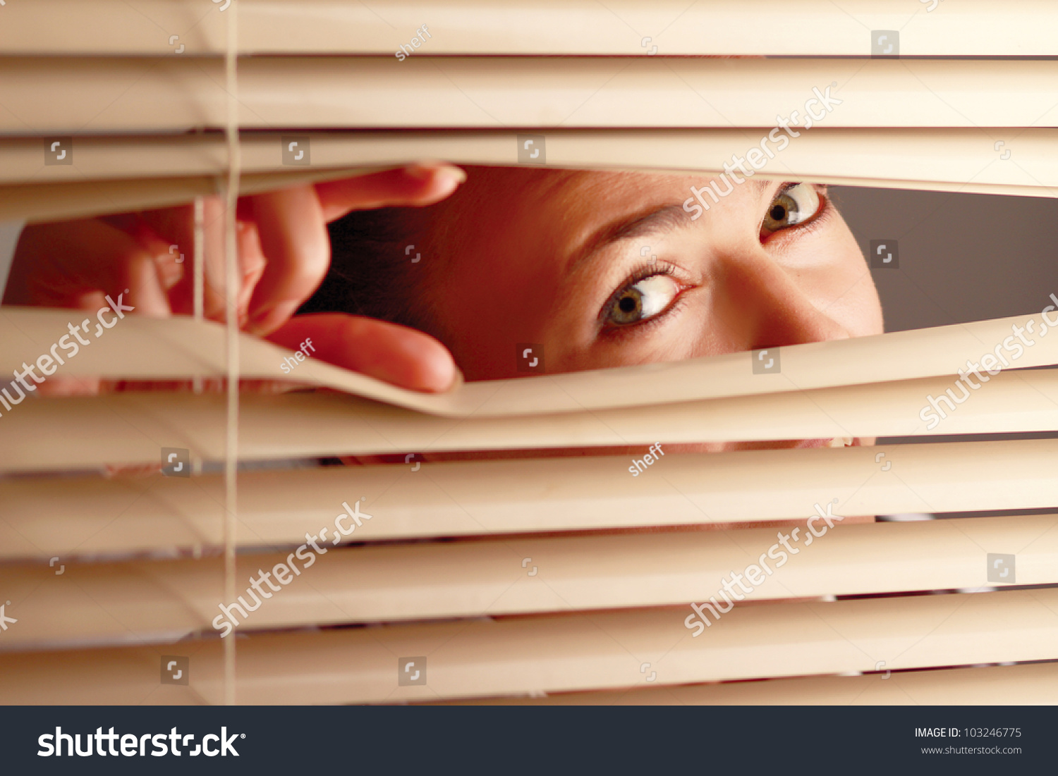 Portrait Of A Woman Looking Through Out The Blinds Stock Photo ...