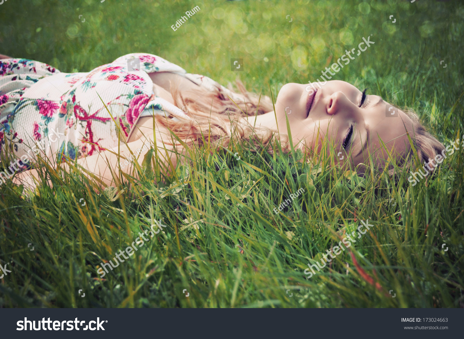 Portrait Of A Young Blonde Woman Lying On Grass With Eyes Shut. Stock ...