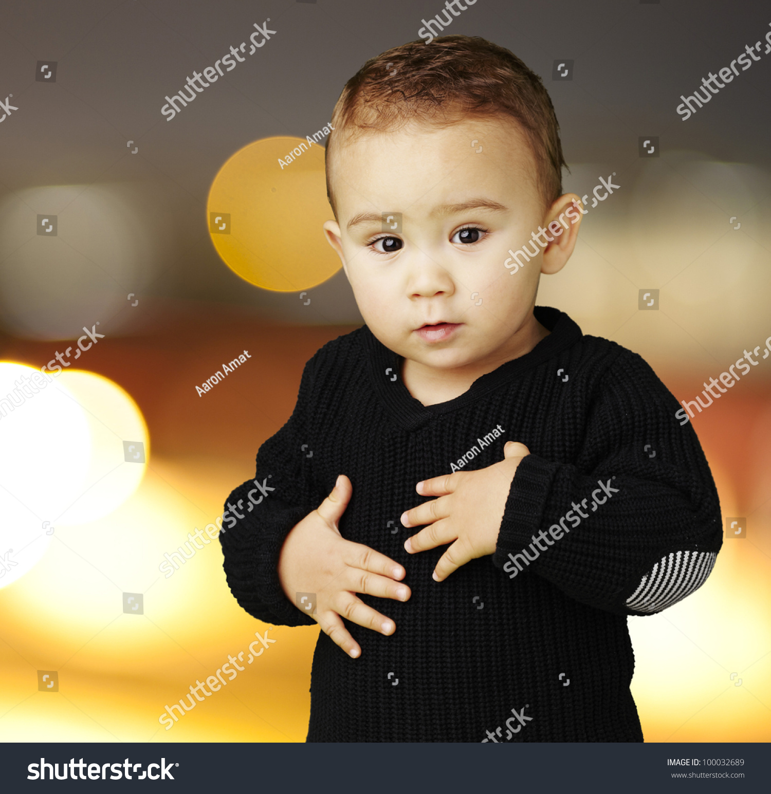 Portrait Of An Adorable Kid Touching His Stomach At A City By Night ...