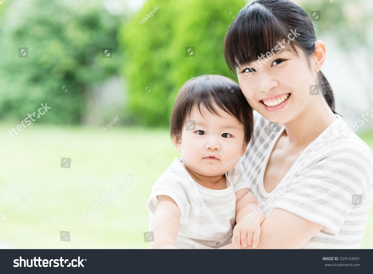 Portrait Of Asian Mother And Baby Relaxing In The Garden Stock Photo ...