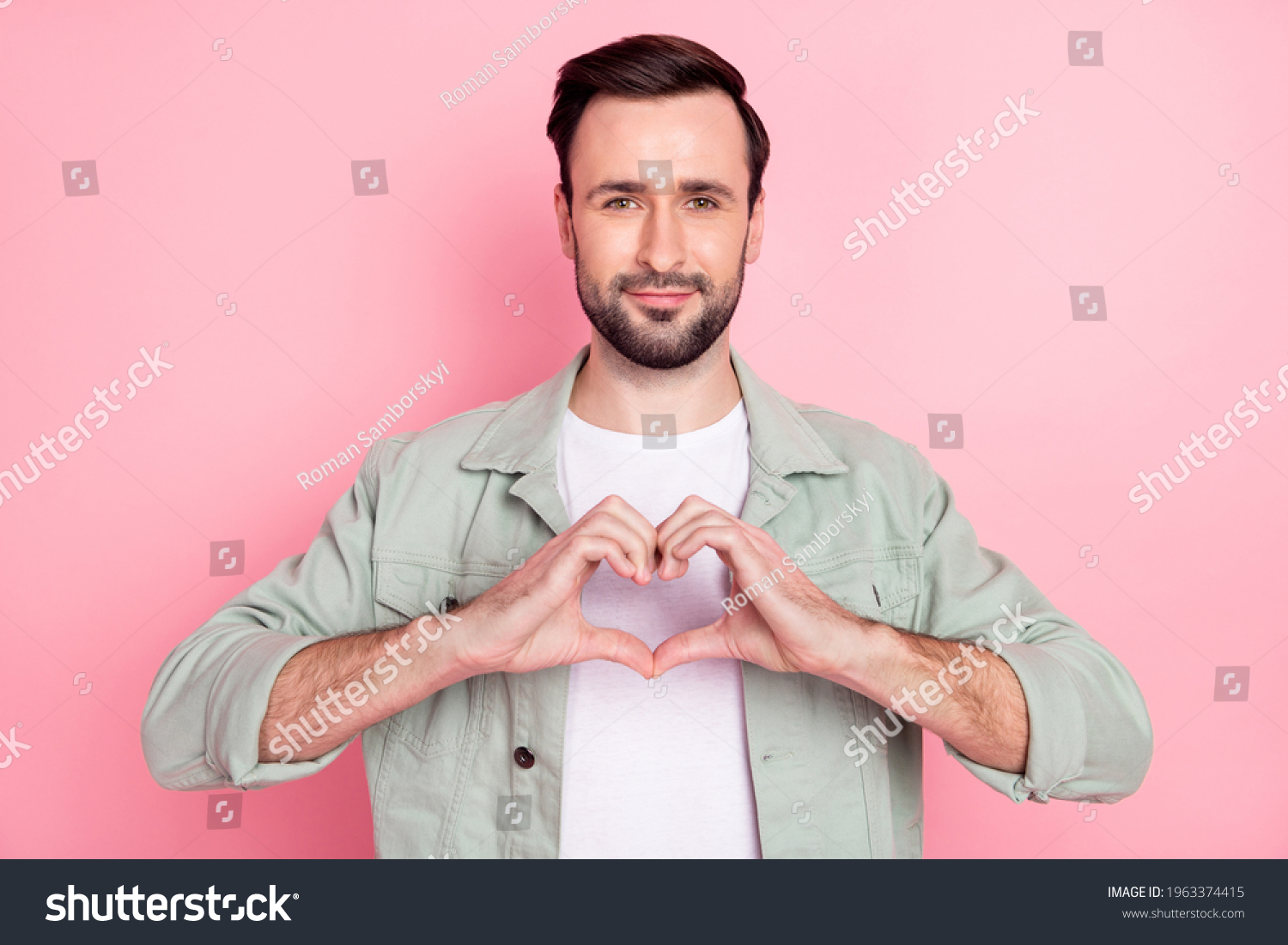 portrait-attractive-cheerful-guy-showing-heart-stock-photo-1963374415