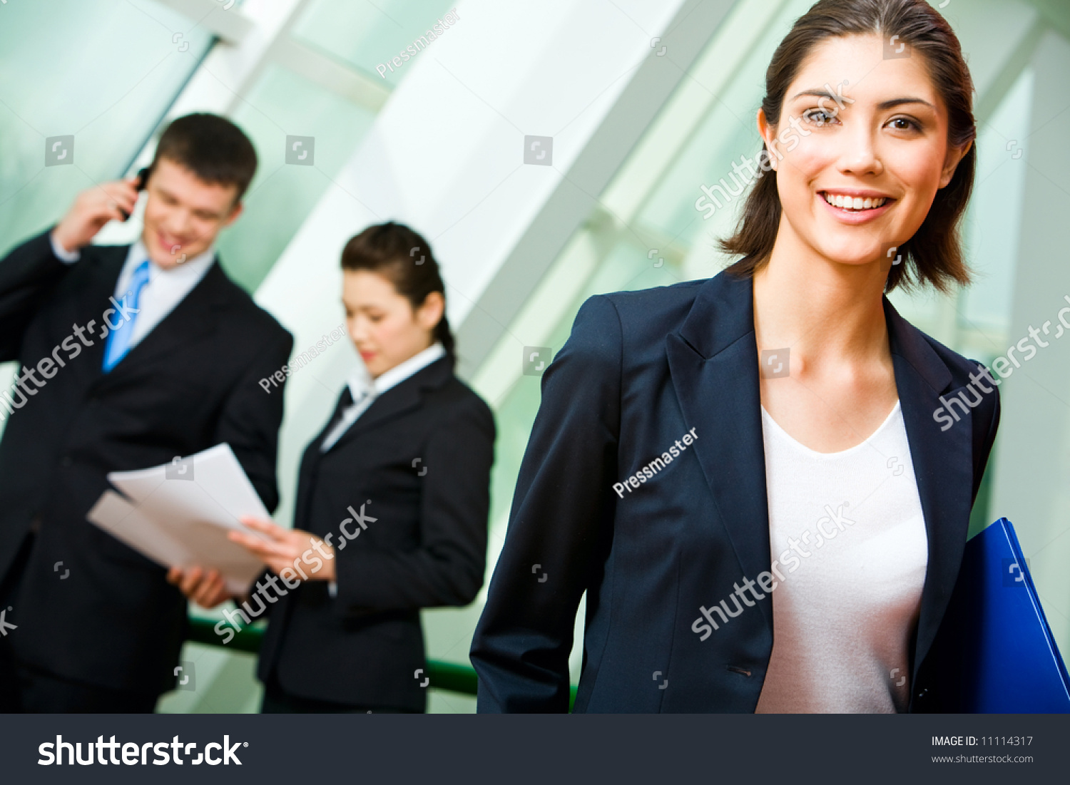 Portrait Of Cheerful Employee In Suit Holding The Folder On The ...