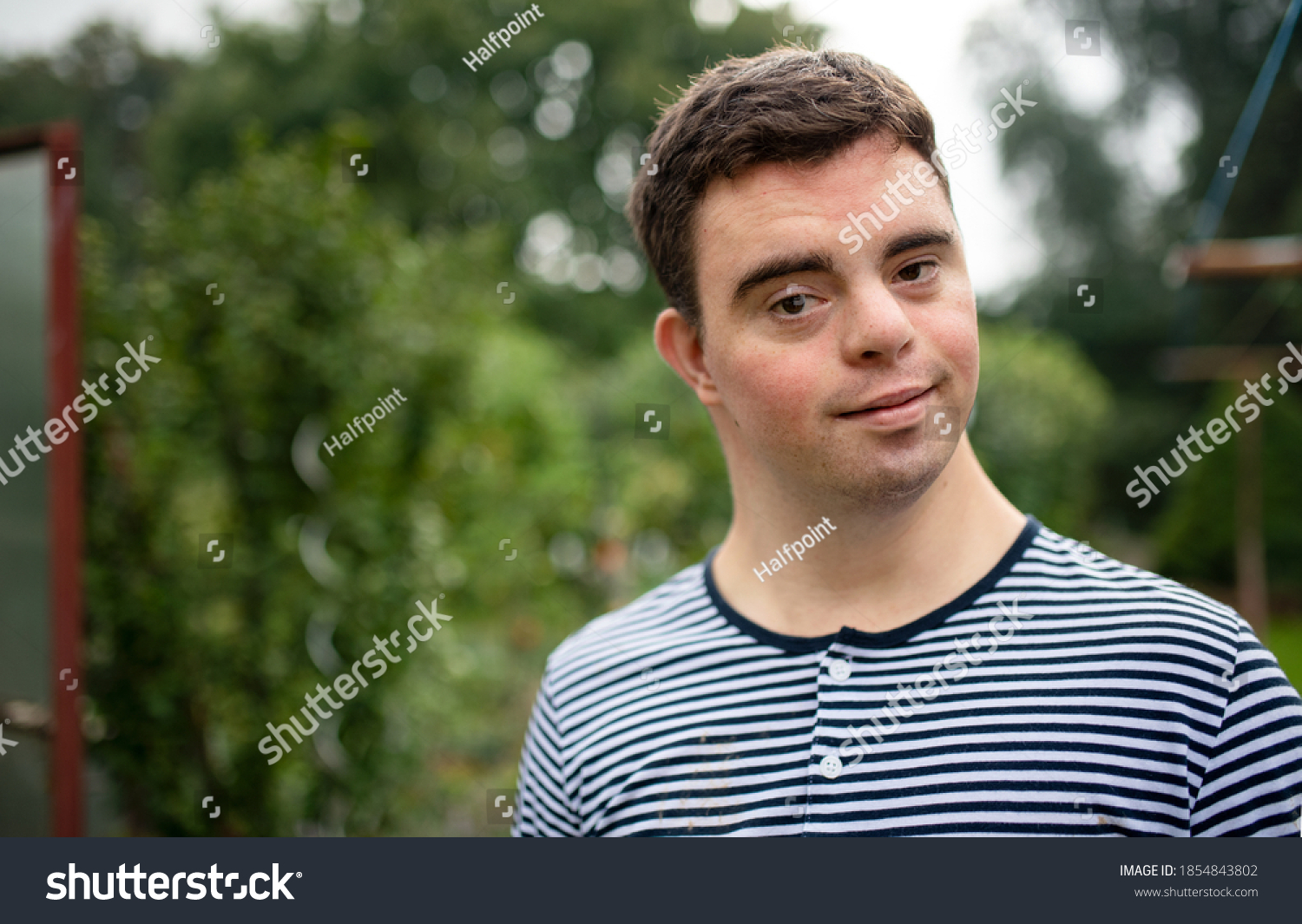 portrait-down-syndrome-adult-man-standing-1854843802-shutterstock