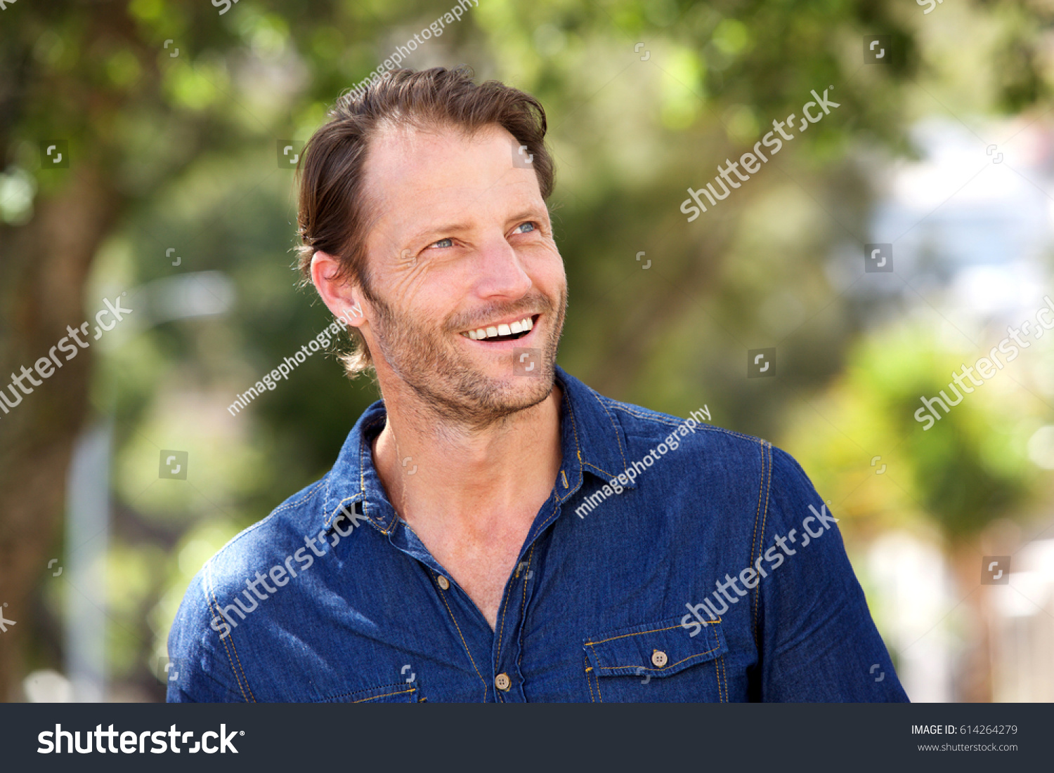 portrait-handsome-older-guy-smiling-outside-stock-photo-614264279