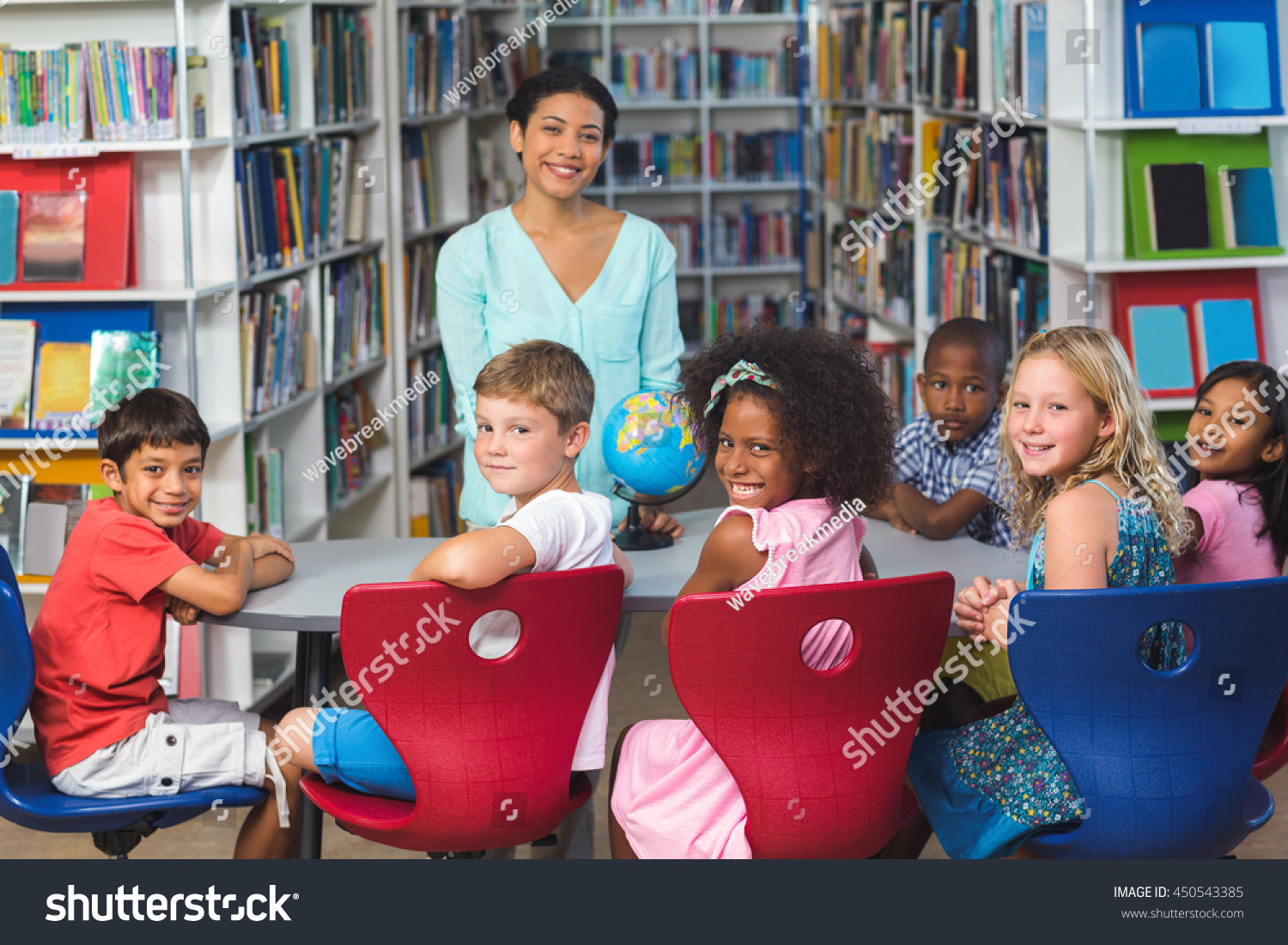 portrait-happy-children-female-teacher-library-stock-photo-450543385