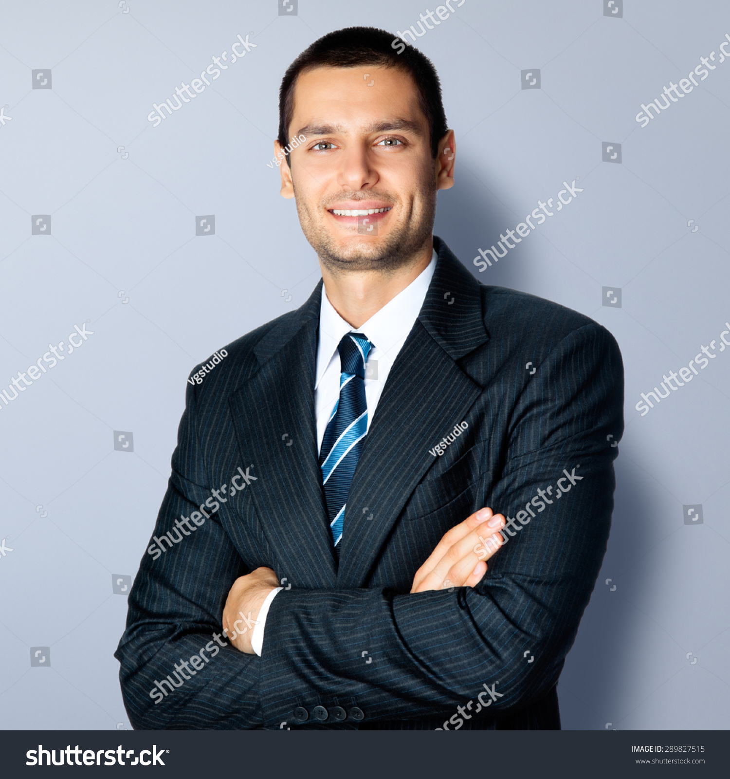 Portrait Of Happy Smiling Businessman In Crossed Arms Pose, In Black ...