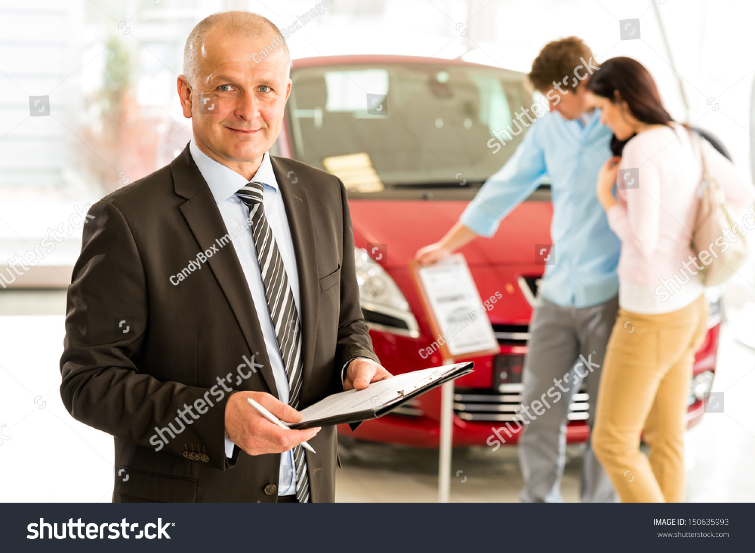 Portrait Of Middle Aged Salesman In Car Retail Store Stock Photo ...