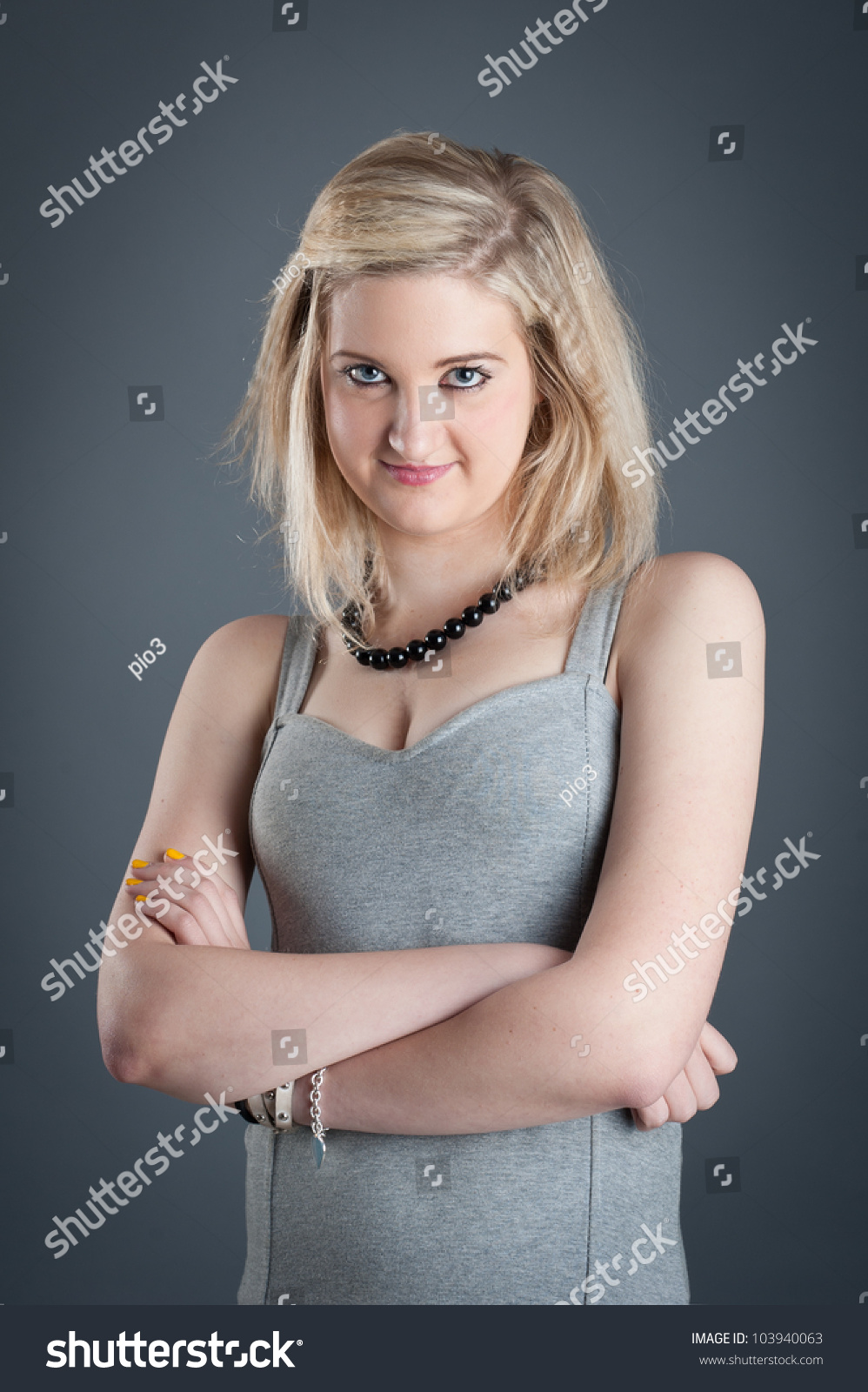 Portrait Of Satisfied Blonde Teenager Girl On Dark Background. Stock ...