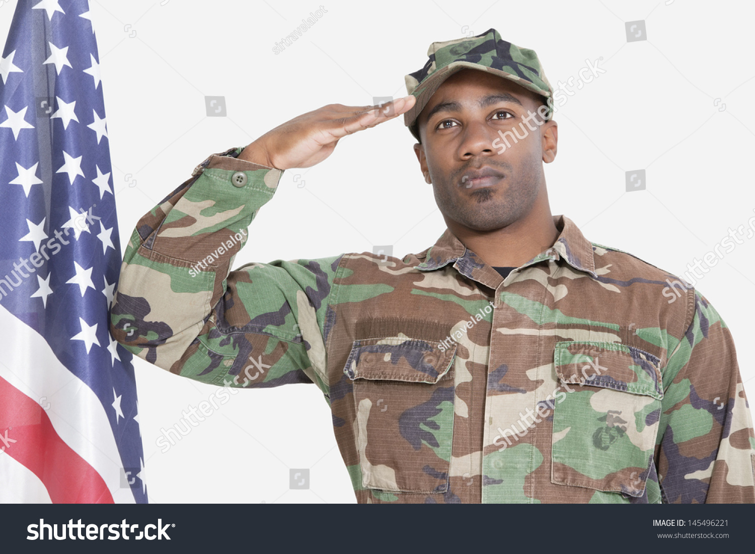 stock-photo-portrait-of-us-marine-corps-soldier-saluting-american-flag-over-gray-background-145496221.jpg