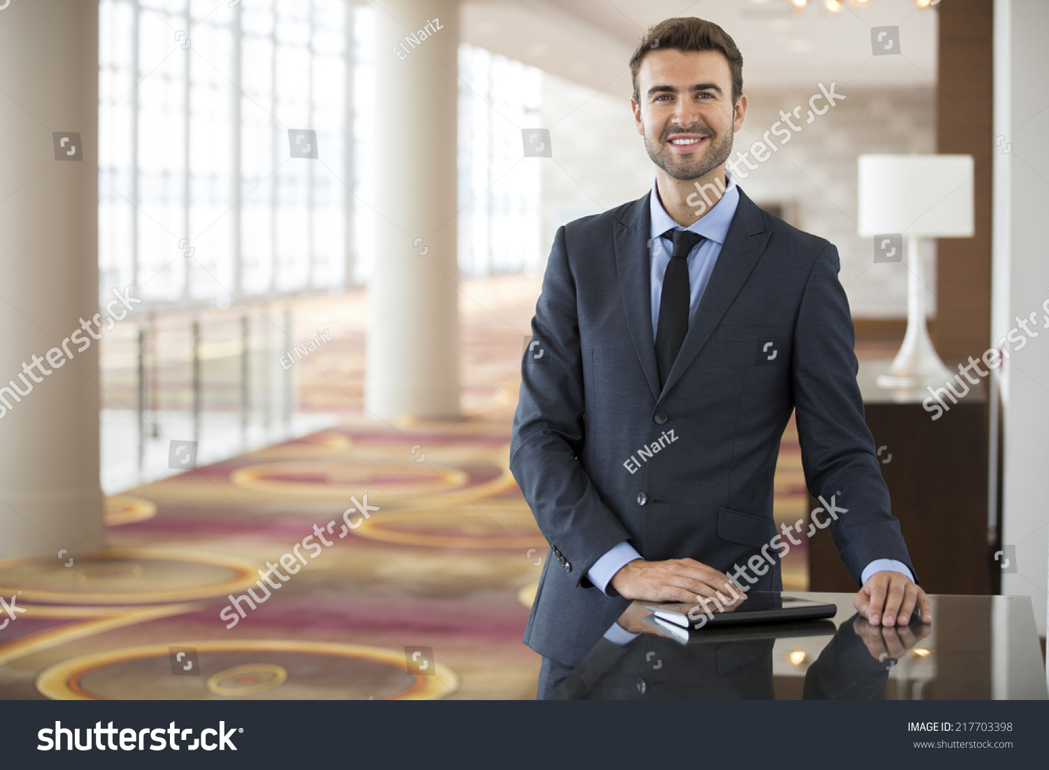 1 820 Sales Manager Hotel Images Stock Photos Vectors Shutterstock   Stock Photo Portrait Of Young Businessman Staring At The Camera In A Hotel Lobby 217703398 