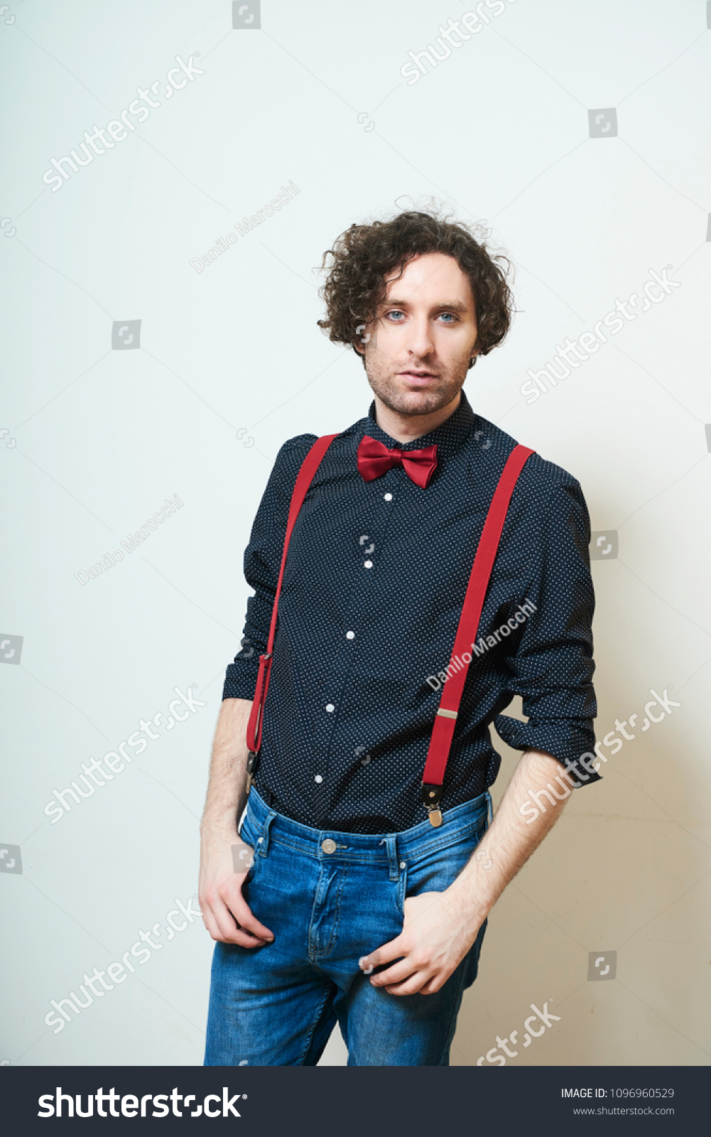 black shirt with red bow tie and suspenders