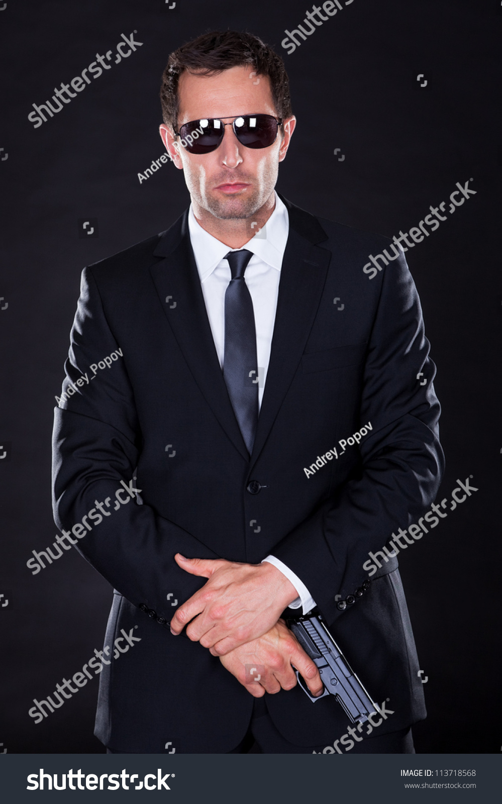 Portrait Of Young Man With Gun On Black Background Stock Photo ...