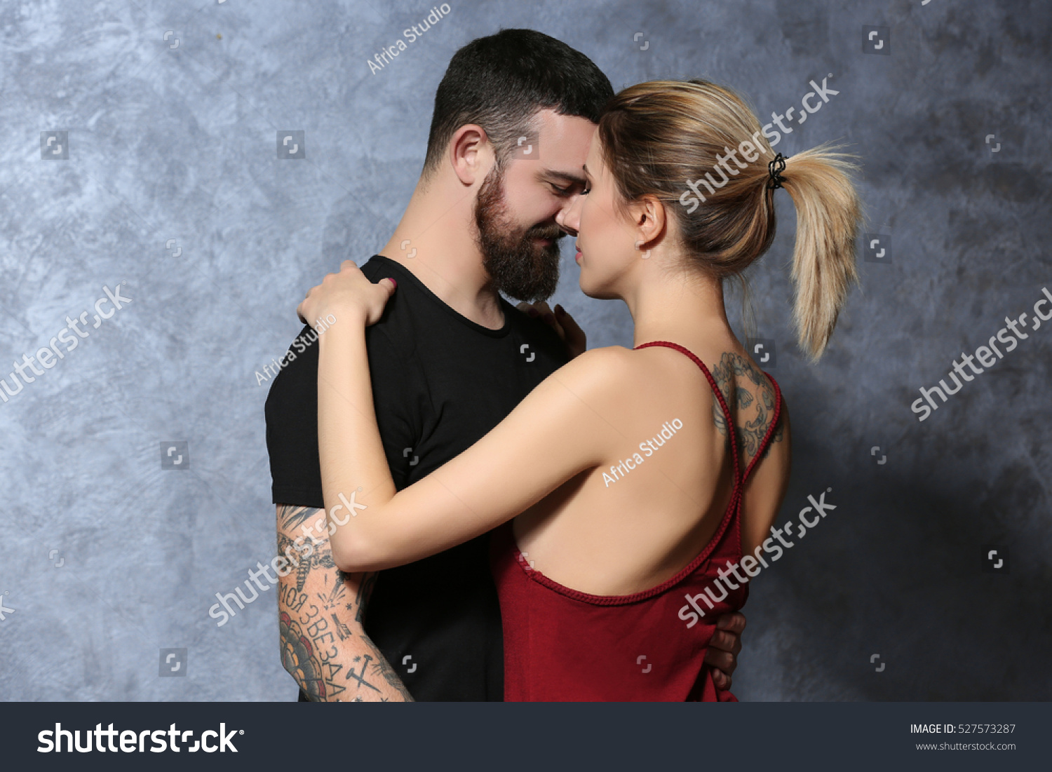 portrait young tattooed couple on gray stock photo 527573287 portrait young tattooed couple on gray stock photo 527573287