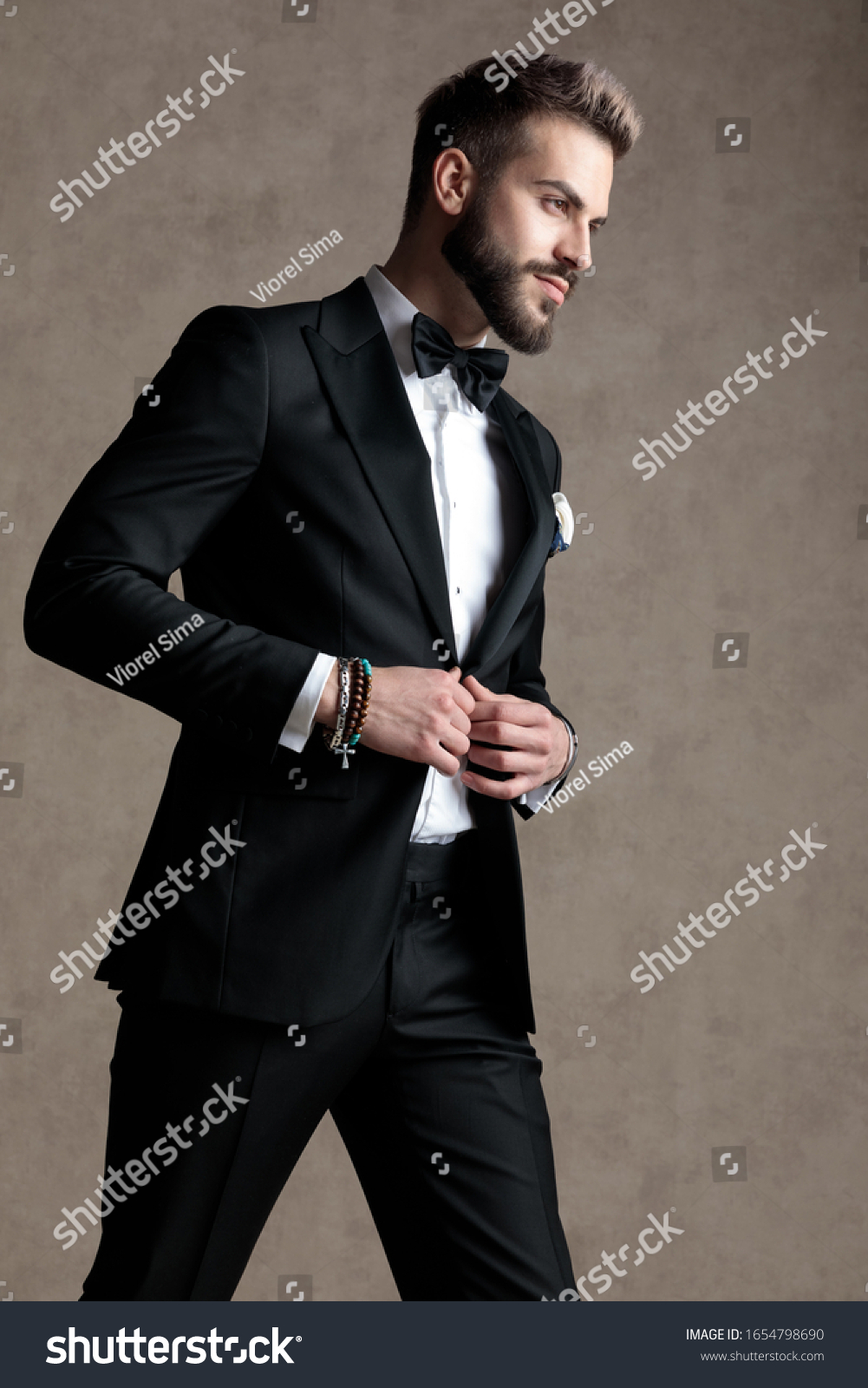 Positive Groom Fixing His Jacket Smiling Stock Photo (Edit Now) 1654798690